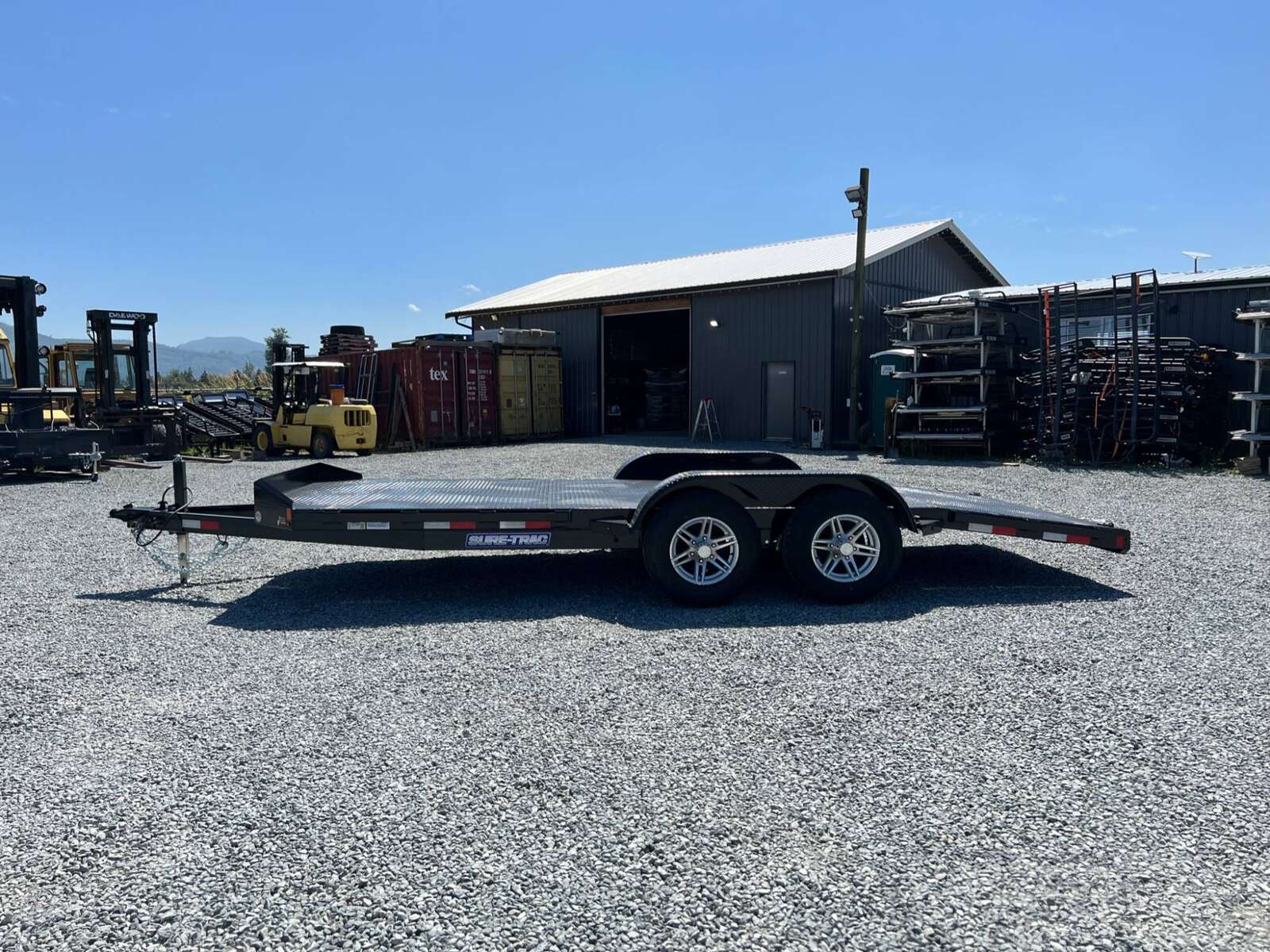 Photo of New Suretrac 7x18 ft Steel Deck Car Hauler Dovetail 9,900lb GVW Flat Deck w/ Slide Out Ramps