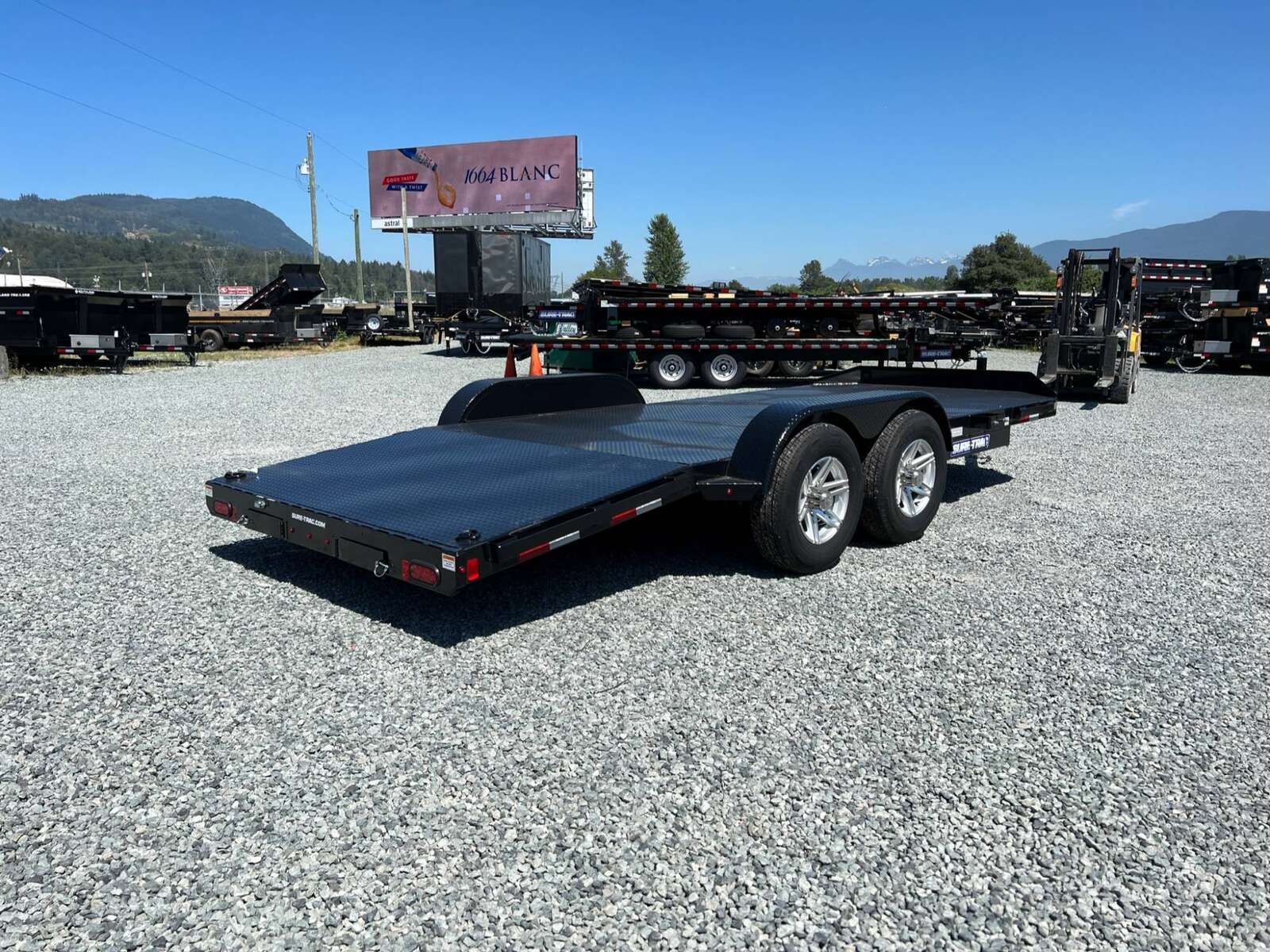 Photo of New Suretrac 7x18 ft Steel Deck Car Hauler Dovetail 9,900lb GVW Flat Deck w/ Slide Out Ramps