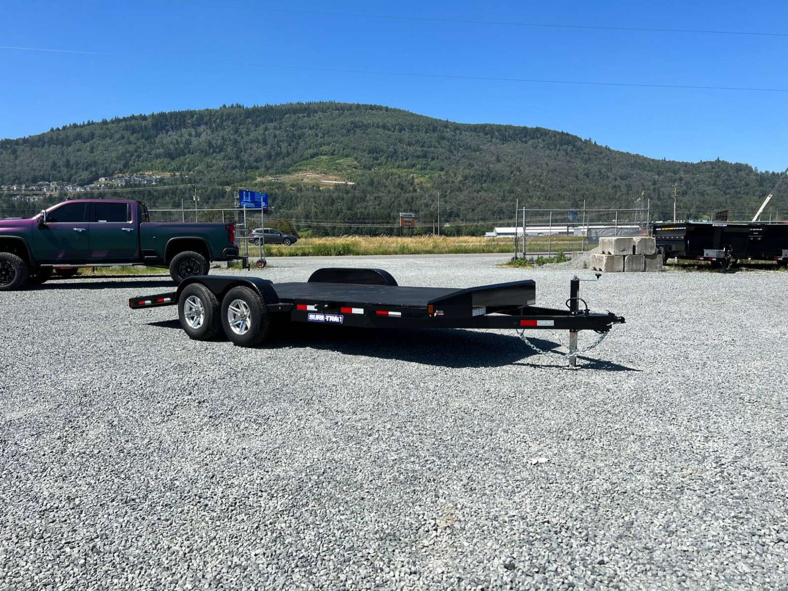 Photo of New Suretrac 7x18 ft Steel Deck Car Hauler Dovetail 9,900lb GVW Flat Deck w/ Slide Out Ramps