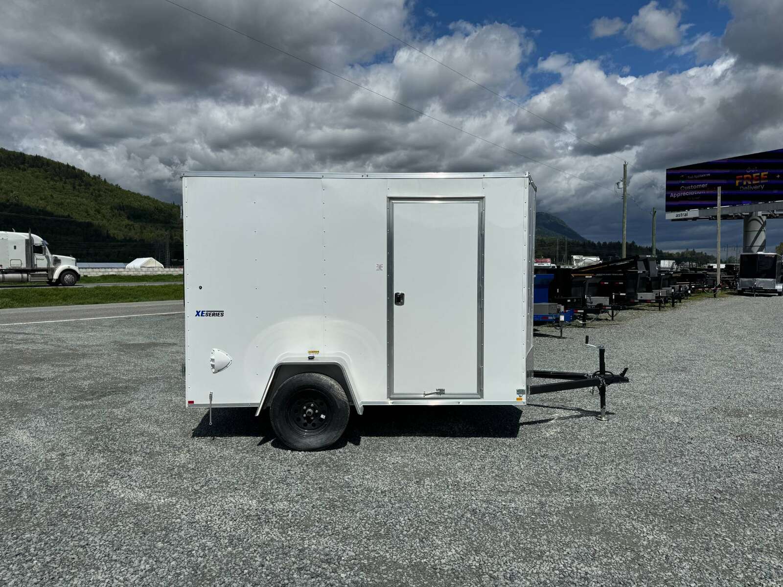 Photo of 2025 Mirage XE 6x10 V Nose Enclosed Cargo Trailer Barn Doors White Extra Height 2990lb GVW