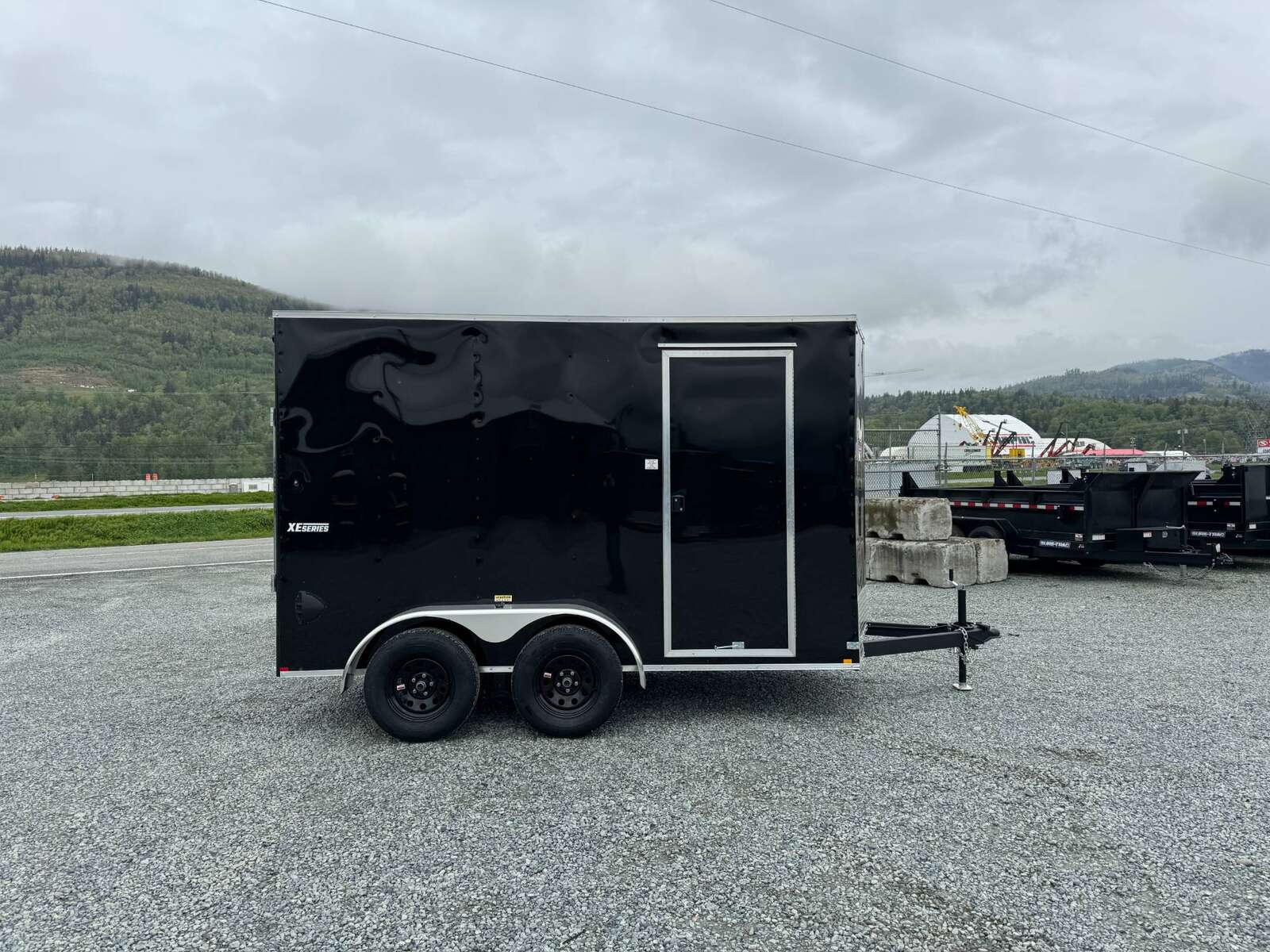 Photo of 2025 Mirage XE 6x12 V Nose Tandem Axle Cargo / Enclosed Trailer Black Ramp Door 77 Inch Interior Height 7,000lb GVW