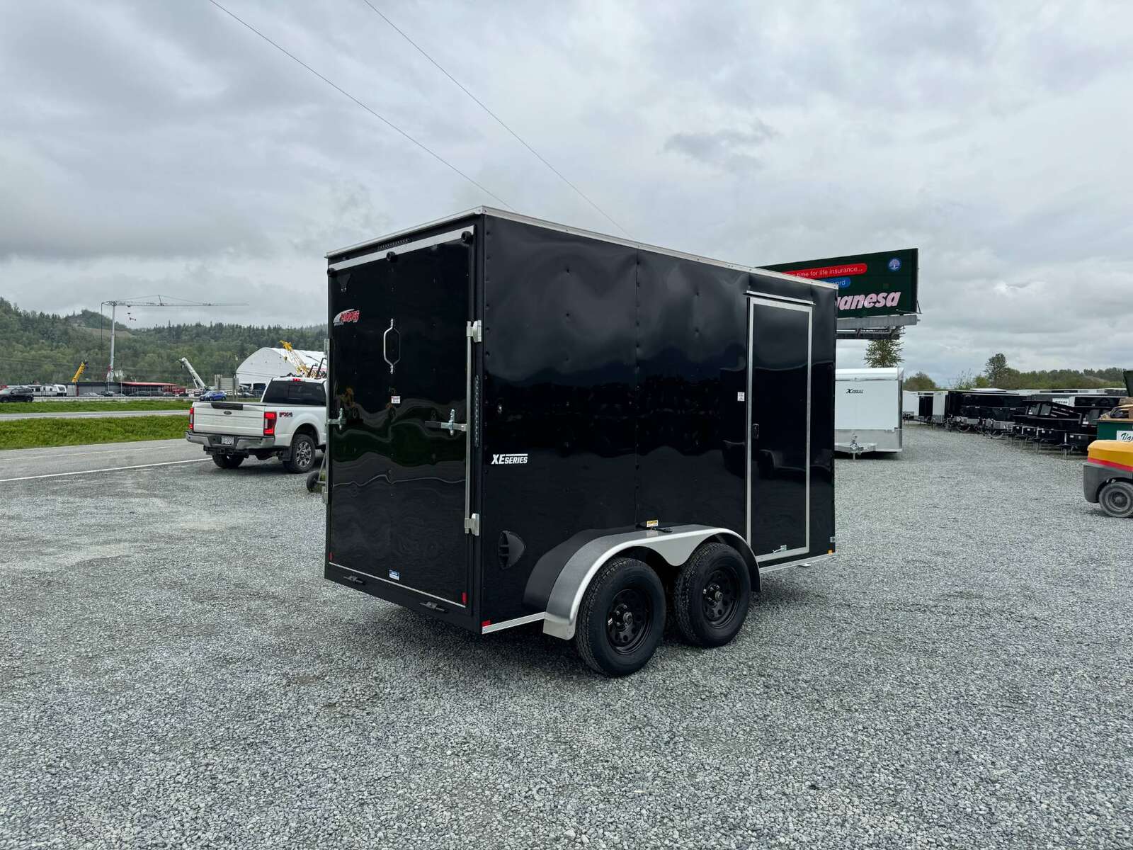 Photo of 2025 Mirage XE 6x12 V Nose Tandem Axle Cargo / Enclosed Trailer Black Ramp Door 77 Inch Interior Height 7,000lb GVW