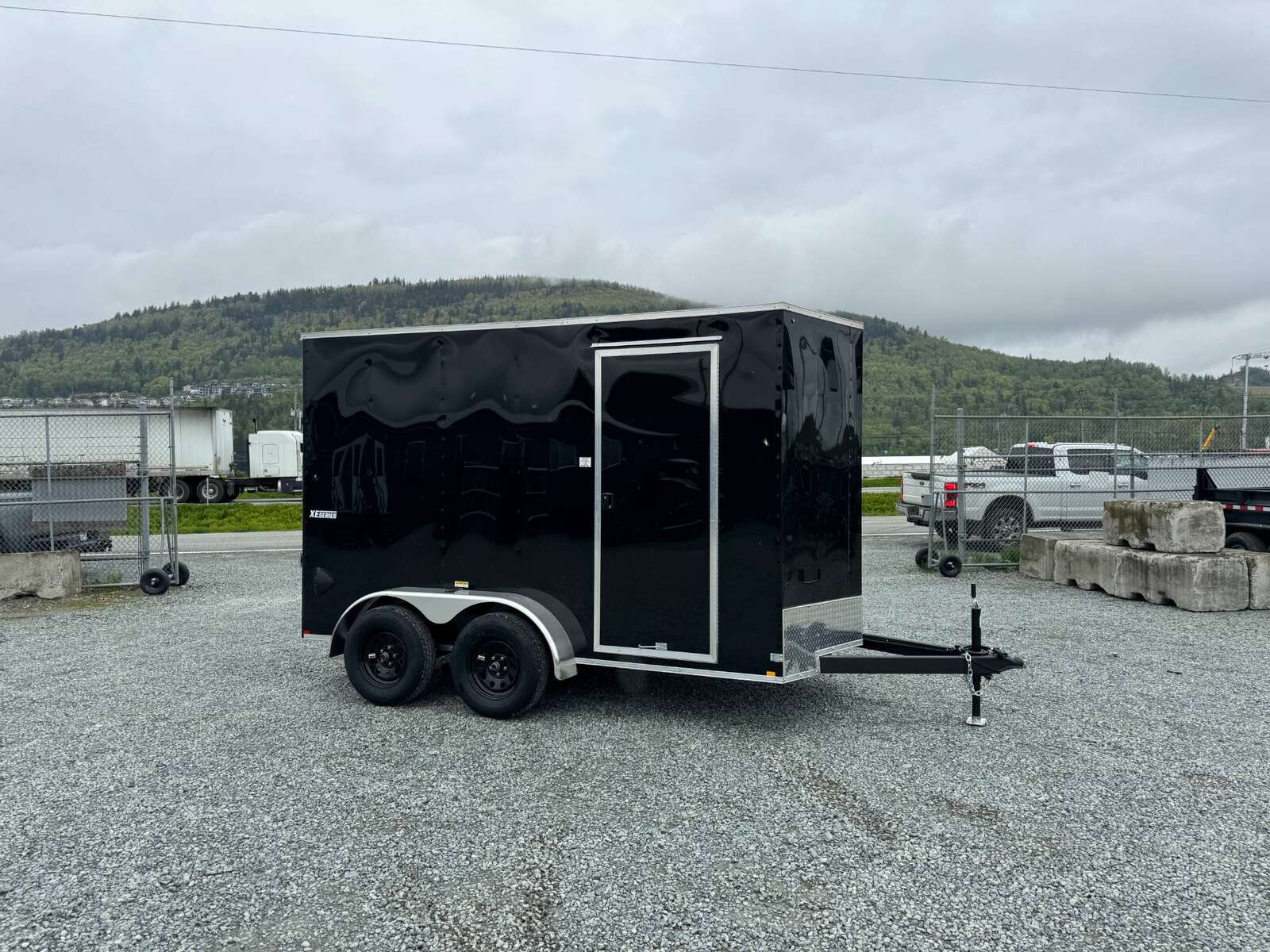 Photo of 2025 Mirage XE 6x12 V Nose Tandem Axle Cargo / Enclosed Trailer Black Ramp Door 77 Inch Interior Height 7,000lb GVW