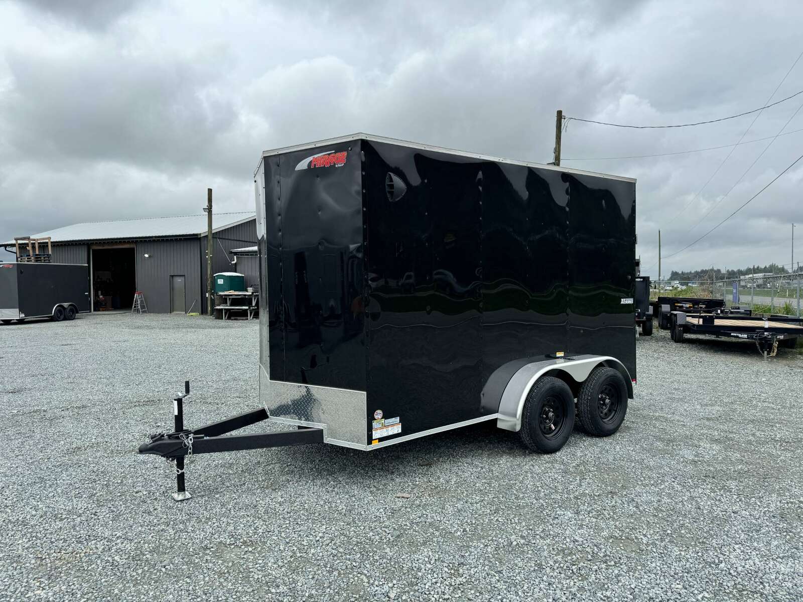 Photo of 2025 Mirage XE 6x12 V Nose Tandem Axle Cargo / Enclosed Trailer Black Ramp Door 77 Inch Interior Height 7,000lb GVW