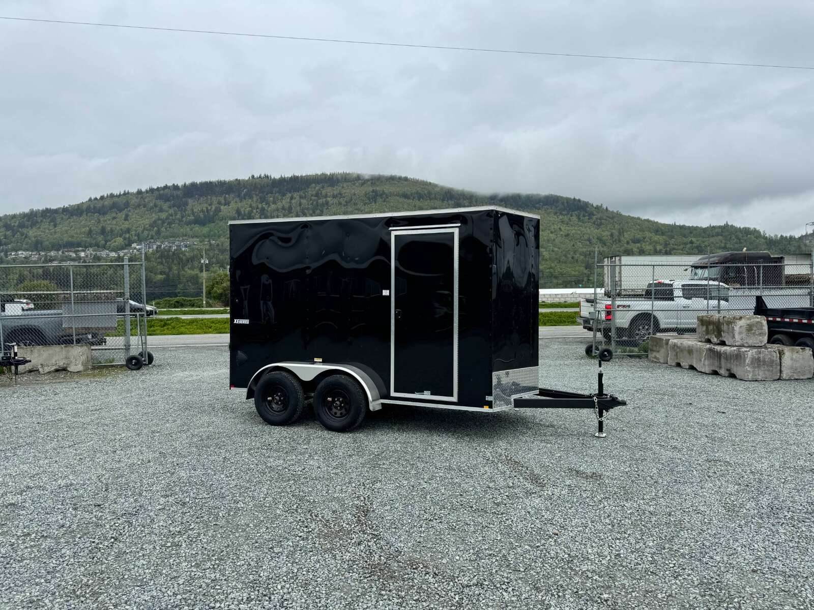 Photo of 2025 Mirage XE 6x12 V Nose Tandem Axle Cargo / Enclosed Trailer Black Ramp Door 77 Inch Interior Height 7,000lb GVW