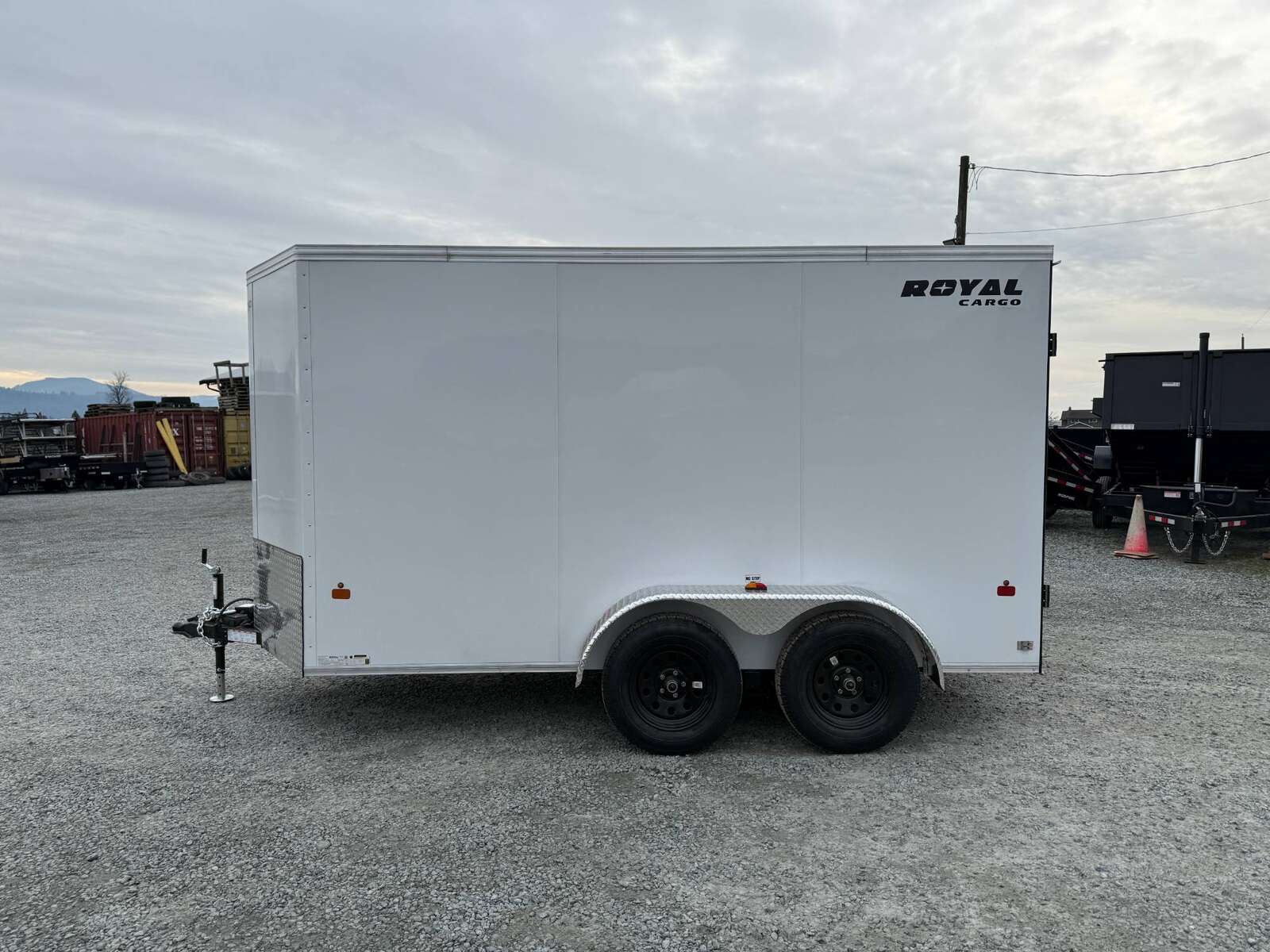 Photo of 2025 Royal Cargo 6x12 Enclosed Trailer Tandem Axle Rear Barn Doors White 7700lbs GVW