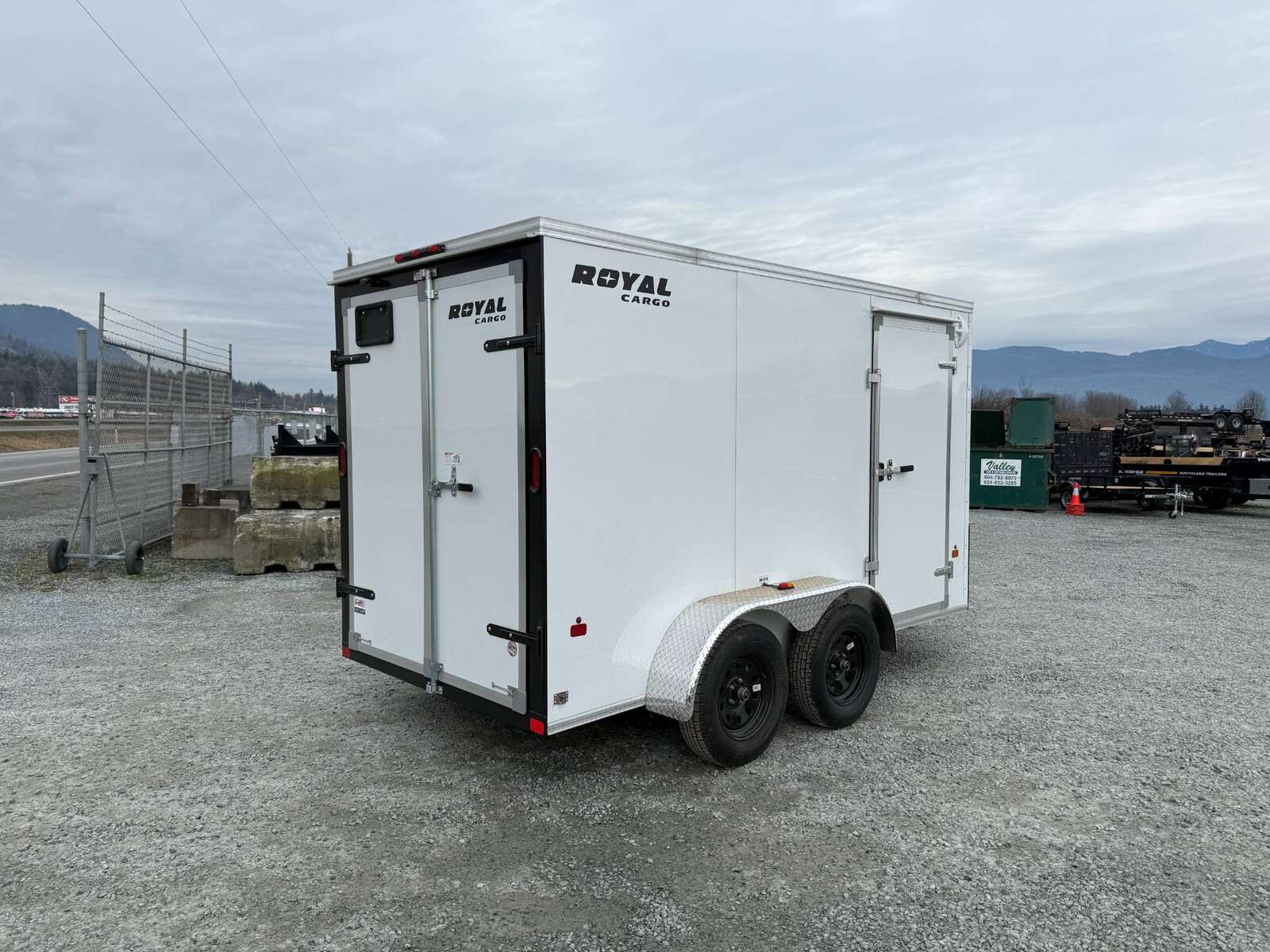 Photo of 2025 Royal Cargo 6x12 Enclosed Trailer Tandem Axle Rear Barn Doors White 7700lbs GVW