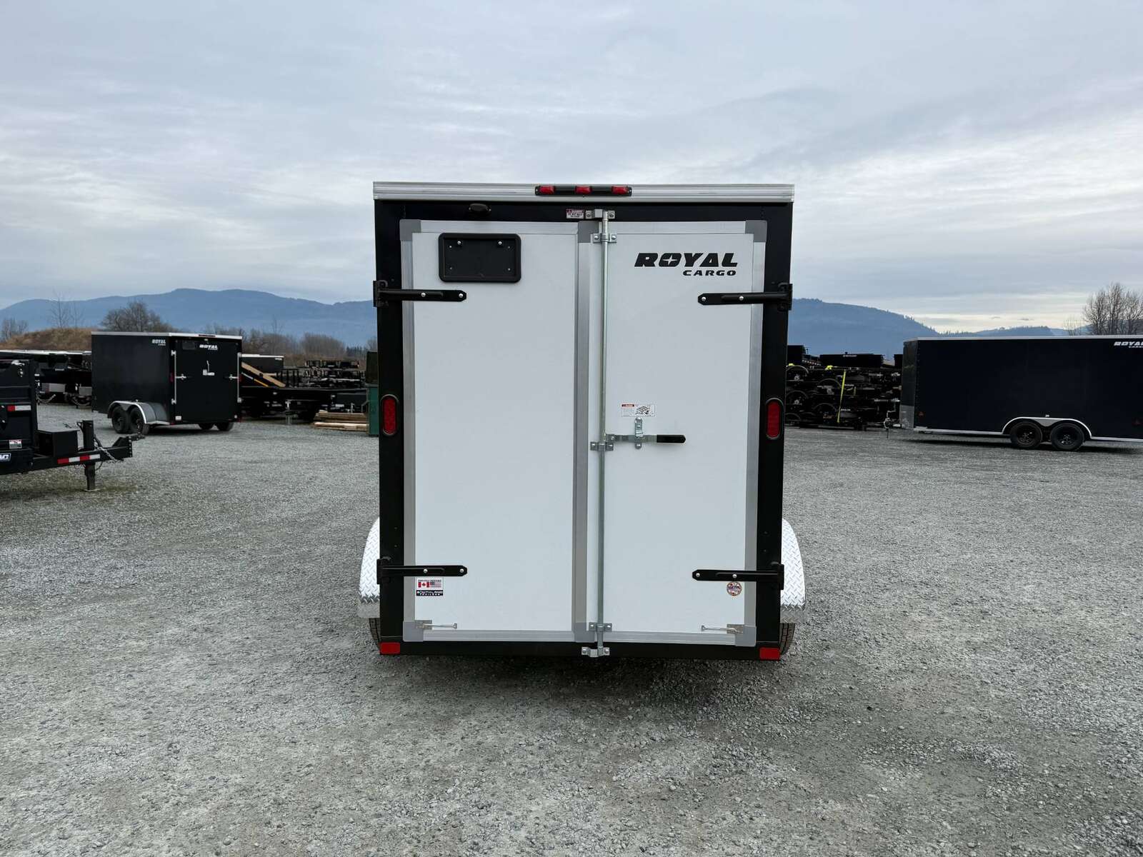 Photo of 2025 Royal Cargo 6x12 Enclosed Trailer Tandem Axle Rear Barn Doors White 7700lbs GVW