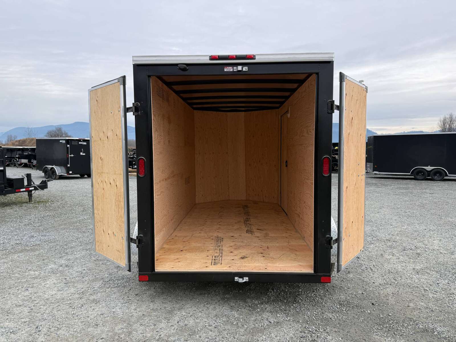 Photo of 2025 Royal Cargo 6x12 Enclosed Trailer Tandem Axle Rear Barn Doors White 7700lbs GVW