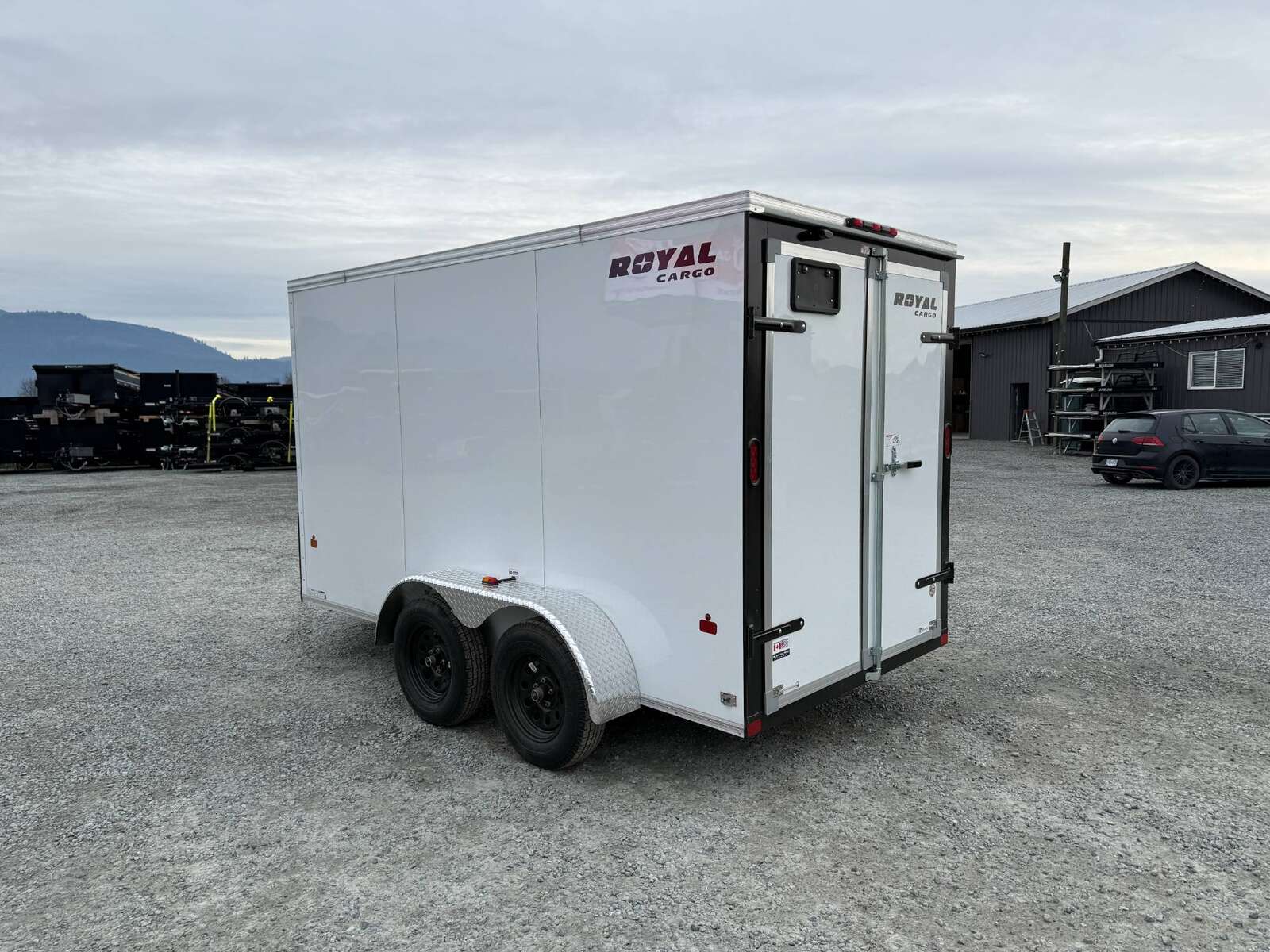 Photo of 2025 Royal Cargo 6x12 Enclosed Trailer Tandem Axle Rear Barn Doors White 7700lbs GVW