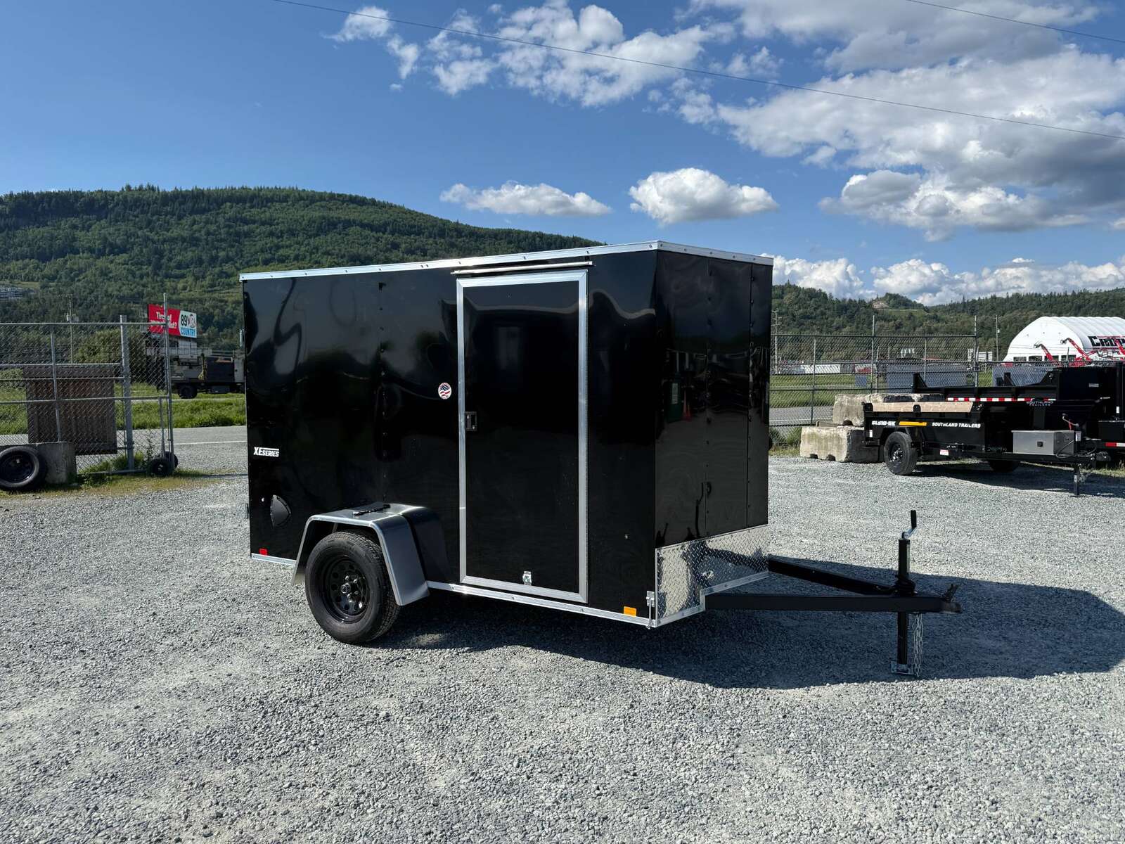Photo of 2025 Mirage XE 6x10 Enclosed Cargo Trailer V Nose Barn Doors Black Standard Height 2990lb GVW