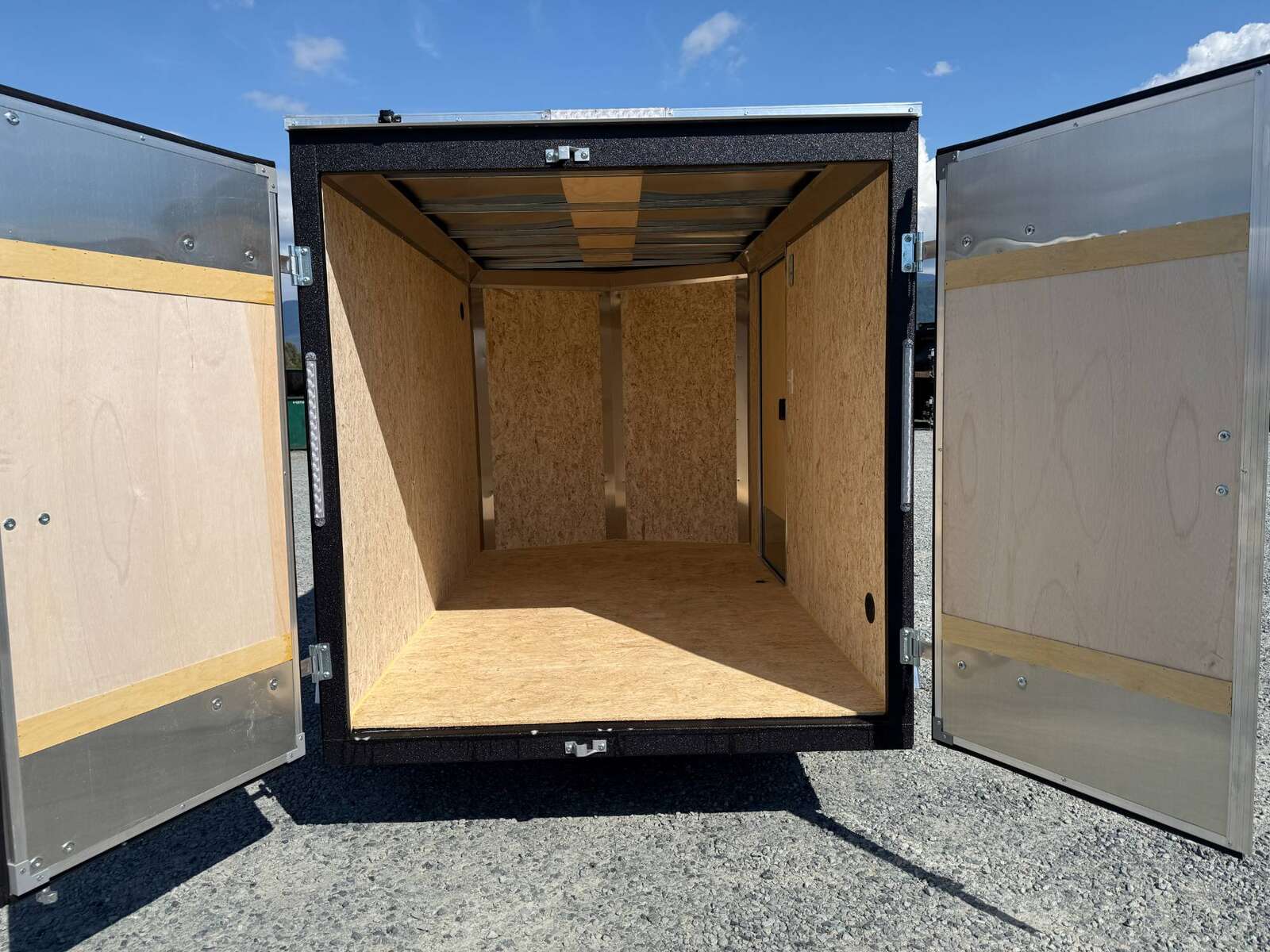 Photo of 2025 Mirage XE 6x10 Enclosed Cargo Trailer V Nose Barn Doors Black Standard Height 2990lb GVW