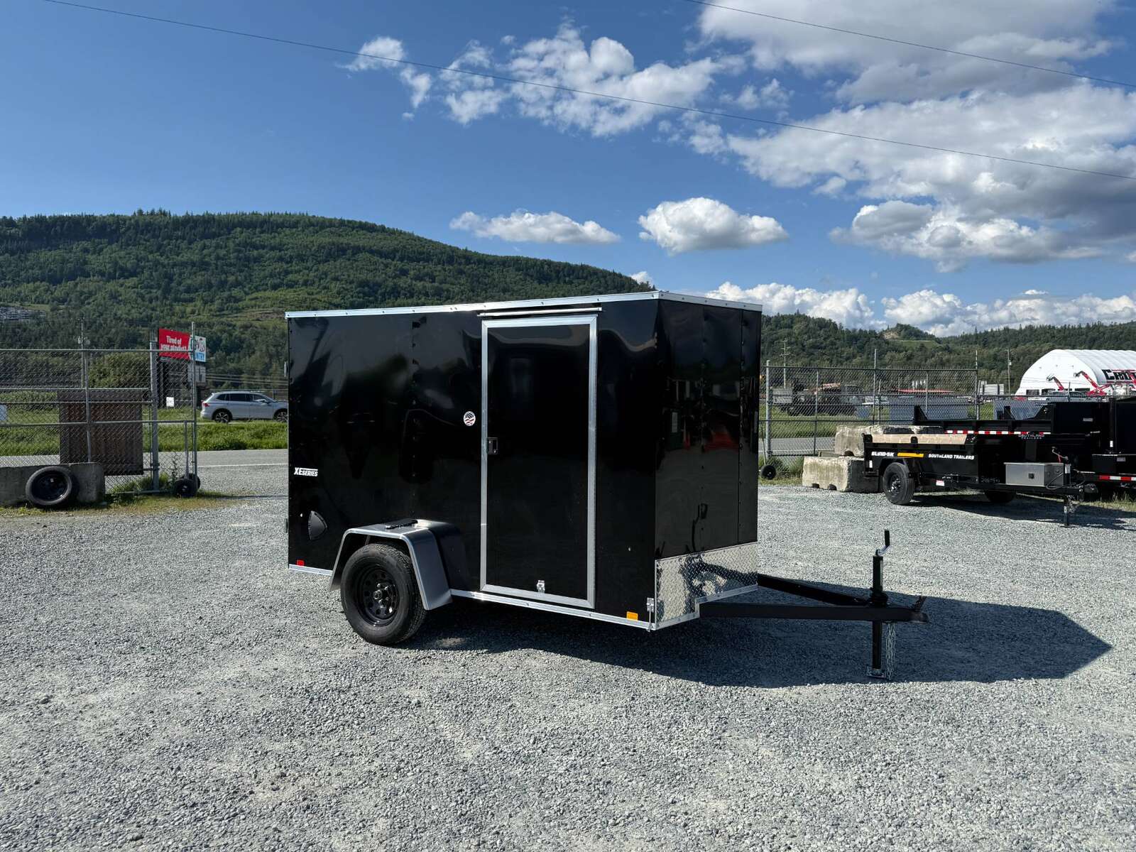 Photo of 2025 Mirage XE 6x10 Enclosed Cargo Trailer V Nose Barn Doors Black Standard Height 2990lb GVW