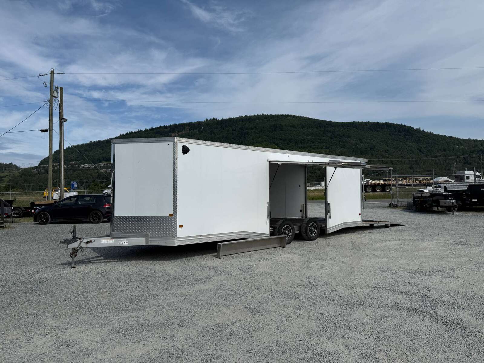 Photo of Pre Owned Used 2022 Alcom Stealth 8.5x24 V Nose Enclosed Cargo Car Hauler Trailer w/ Ramp Door & Elite Side Escape Door & Extended Rear Loading Ramps