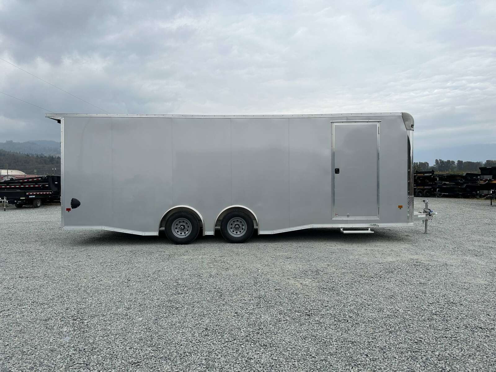 Photo of 2026 ALCOM ALUMINUM 8.5x24 CAR TRAILER 9900lb GVW SILVER LARGE ESCAPE SIDE DOOR CARGO ENCLOSED
