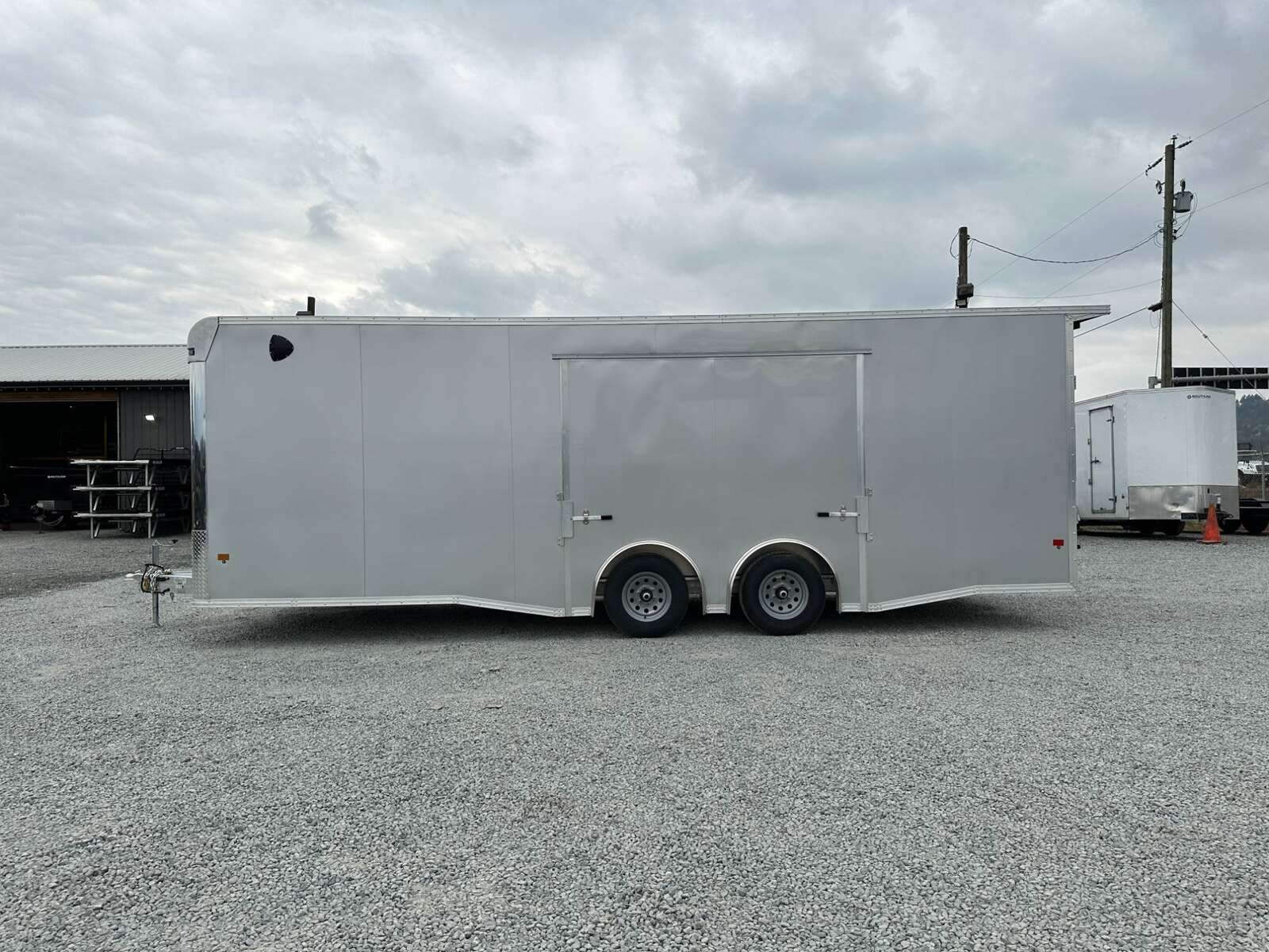 Photo of 2026 ALCOM ALUMINUM 8.5x24 CAR TRAILER 9900lb GVW SILVER LARGE ESCAPE SIDE DOOR CARGO ENCLOSED