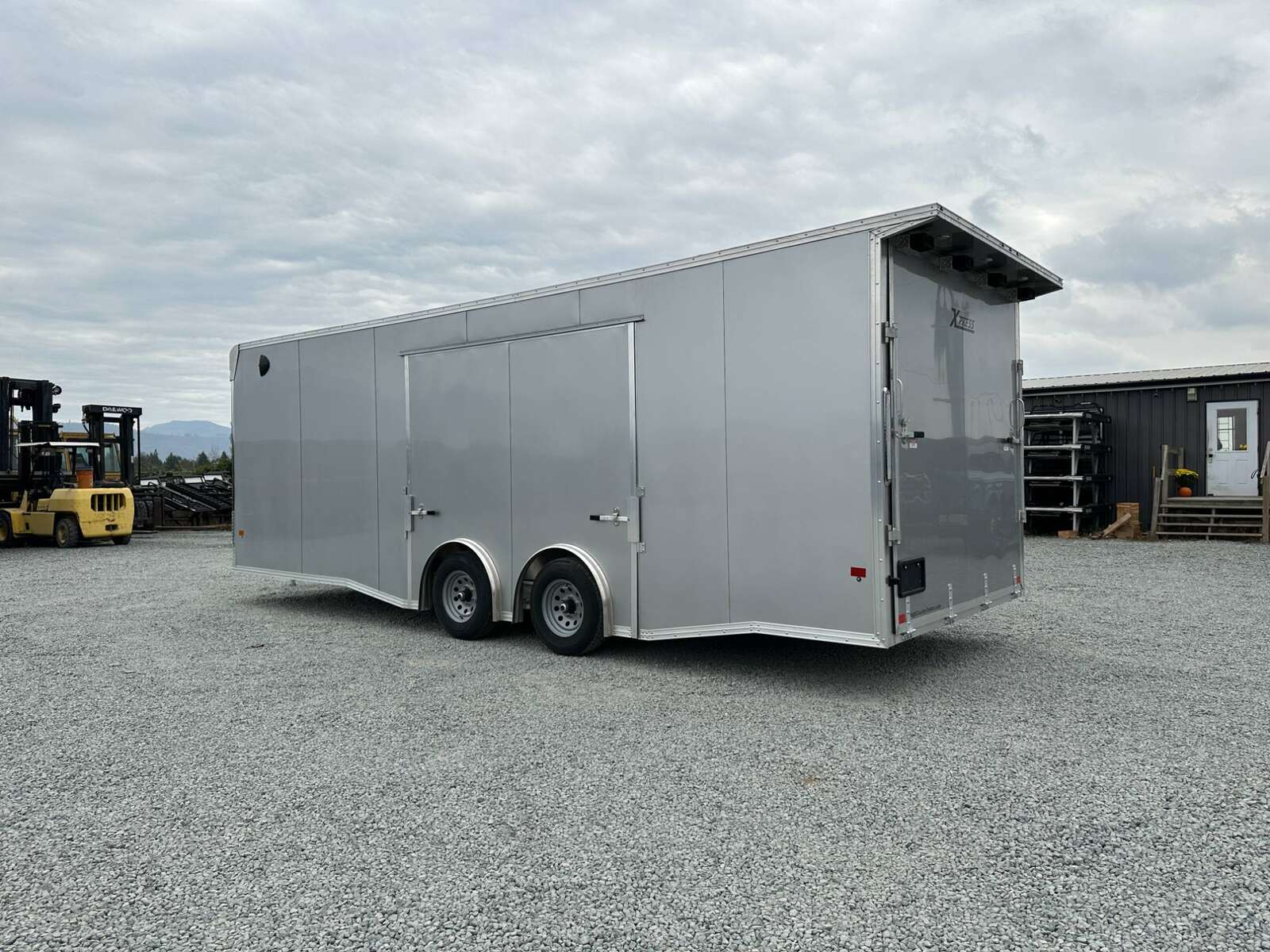 Photo of 2026 ALCOM ALUMINUM 8.5x24 CAR TRAILER 9900lb GVW SILVER LARGE ESCAPE SIDE DOOR CARGO ENCLOSED