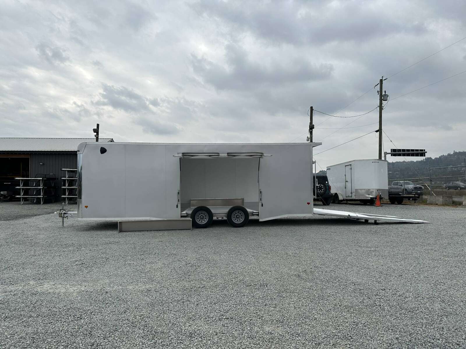 Photo of 2026 ALCOM ALUMINUM 8.5x24 CAR TRAILER 9900lb GVW SILVER LARGE ESCAPE SIDE DOOR CARGO ENCLOSED