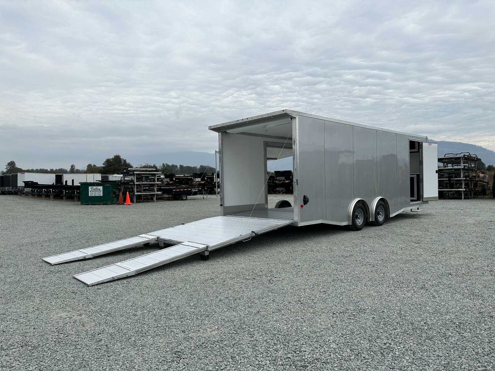 Photo of 2026 ALCOM ALUMINUM 8.5x24 CAR TRAILER 9900lb GVW SILVER LARGE ESCAPE SIDE DOOR CARGO ENCLOSED