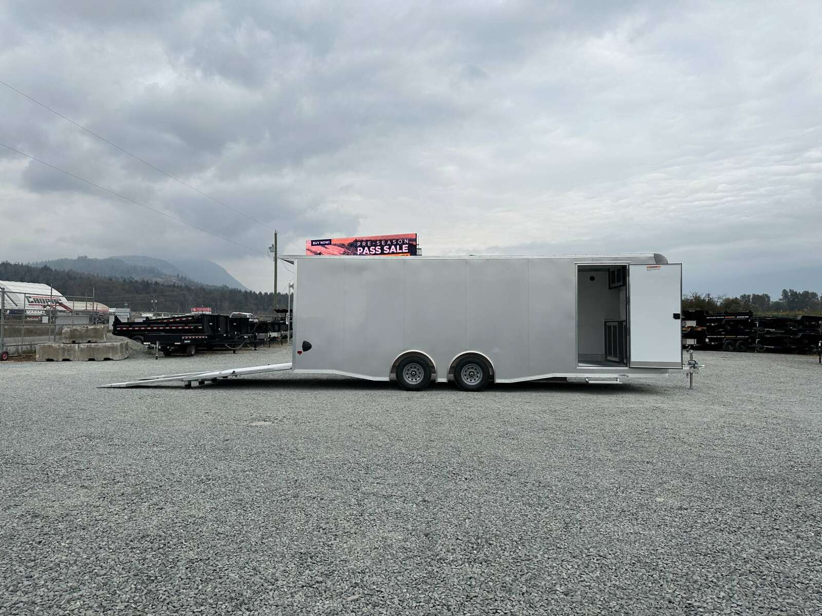 Photo of 2026 ALCOM ALUMINUM 8.5x24 CAR TRAILER 9900lb GVW SILVER LARGE ESCAPE SIDE DOOR CARGO ENCLOSED
