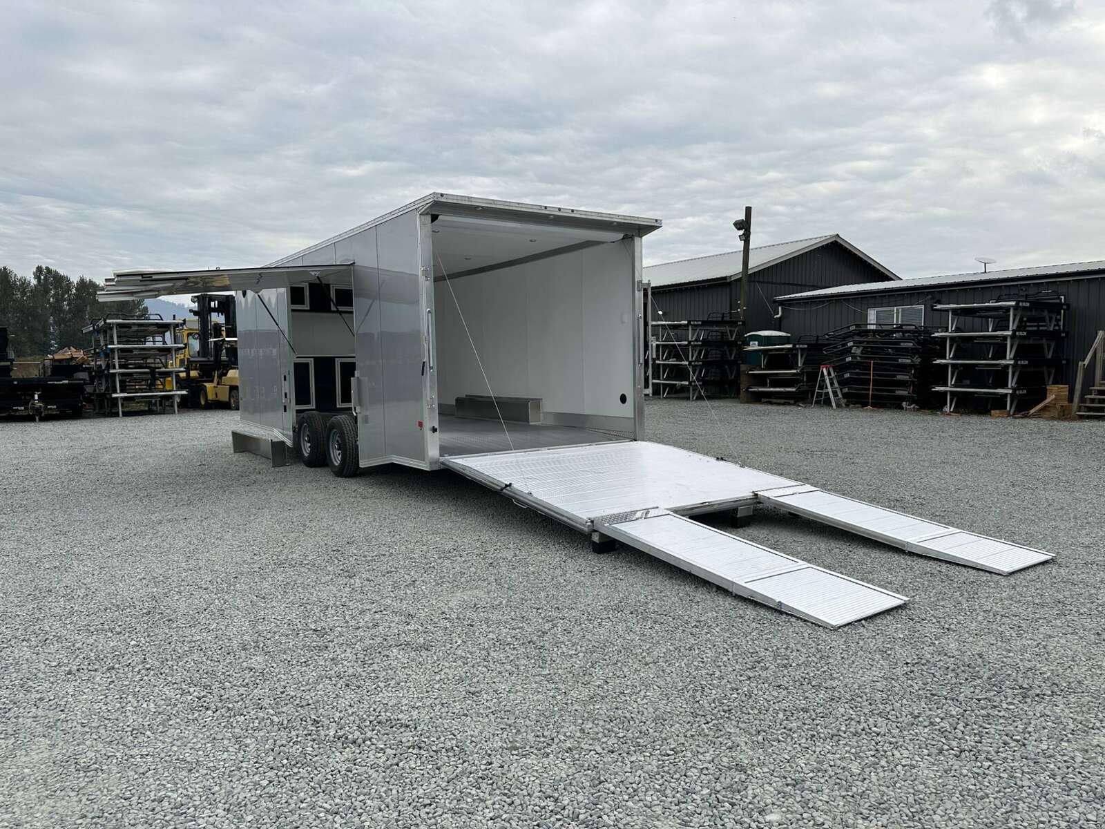 Photo of 2026 ALCOM ALUMINUM 8.5x24 CAR TRAILER 9900lb GVW SILVER LARGE ESCAPE SIDE DOOR CARGO ENCLOSED