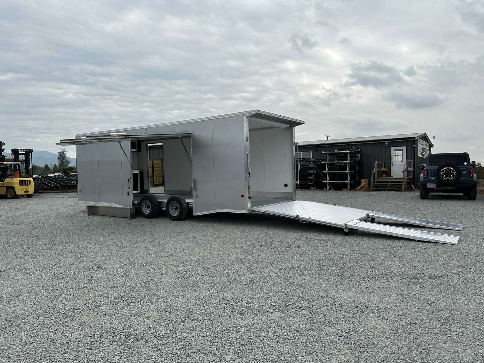 Photo of 2026 ALCOM ALUMINUM 8.5x24 CAR TRAILER 9900lb GVW SILVER LARGE ESCAPE SIDE DOOR CARGO ENCLOSED