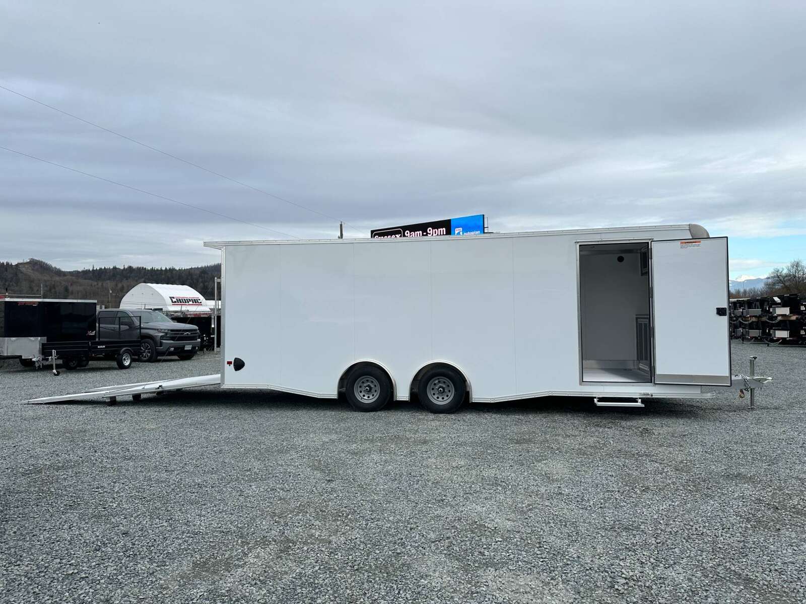 Photo of 2026 ALCOM ALUMINUM 8.5x24 CAR TRAILER 9900lb GVW WHITE LARGE ESCAPE SIDE DOOR CARGO ENCLOSED