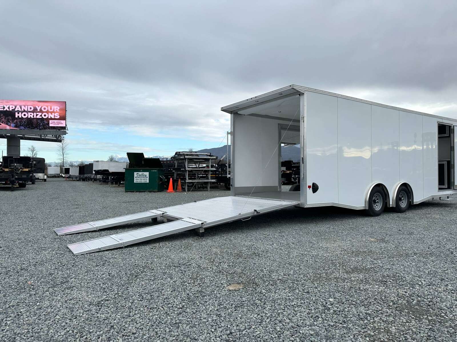 Photo of 2026 ALCOM ALUMINUM 8.5x24 CAR TRAILER 9900lb GVW WHITE LARGE ESCAPE SIDE DOOR CARGO ENCLOSED