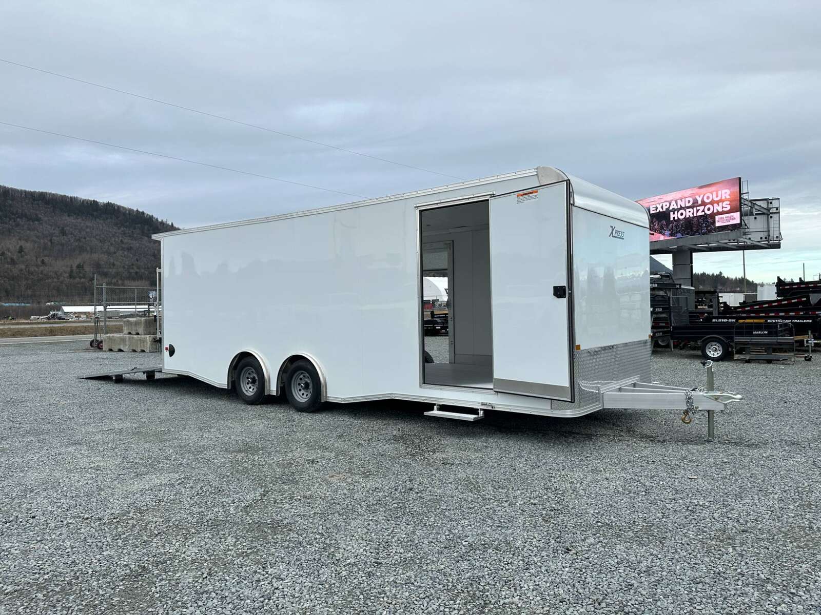 Photo of 2026 ALCOM ALUMINUM 8.5x24 CAR TRAILER 9900lb GVW WHITE LARGE ESCAPE SIDE DOOR CARGO ENCLOSED