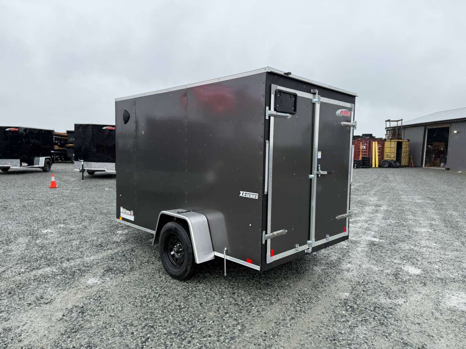Photo of 2026 Mirage XE 6x10 Enclosed Cargo Trailer V Nose Barn Doors Charcoal Grey Standard Height 2990lb GVW
