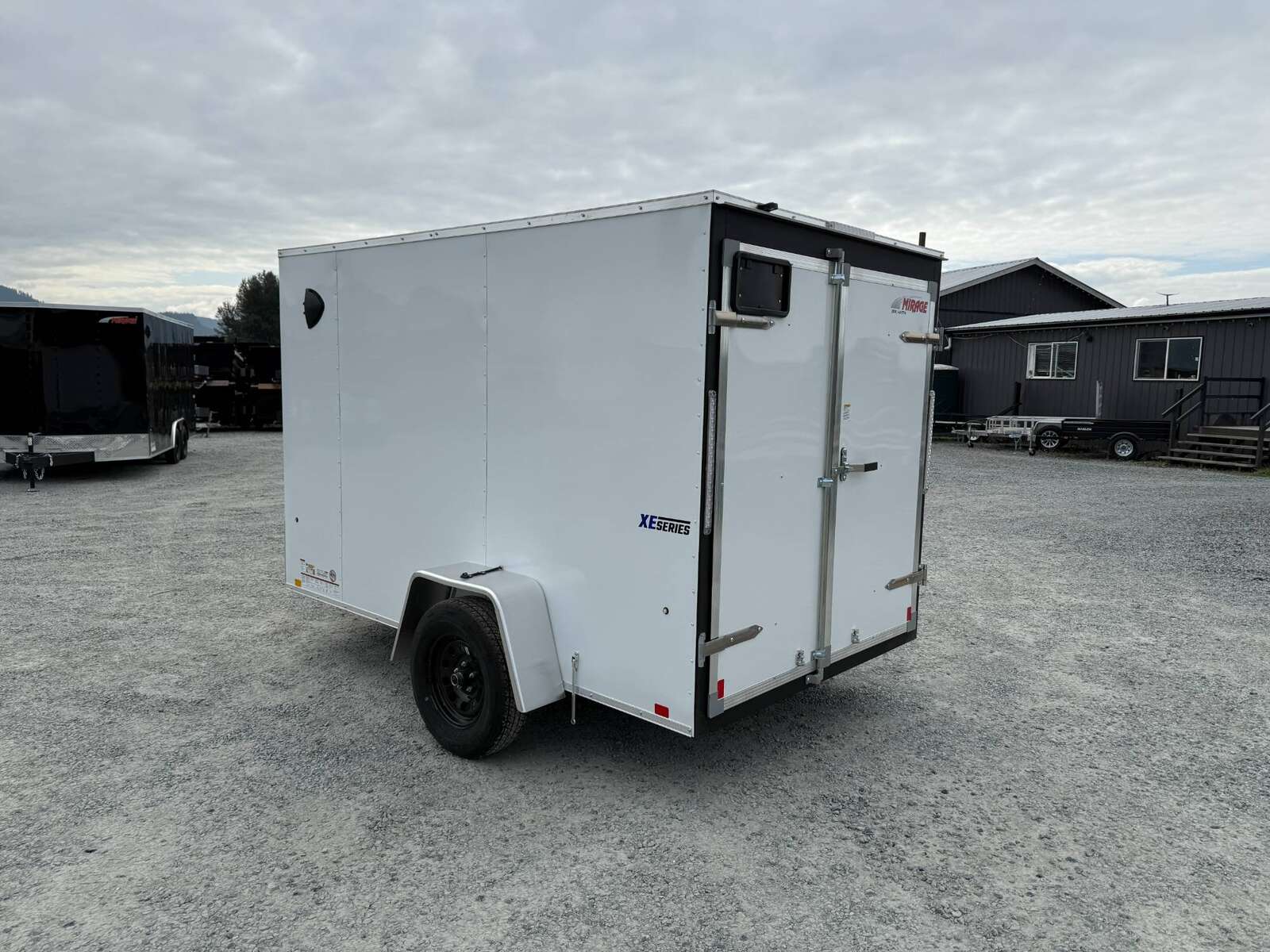Photo of 2026 Mirage XE 6x10 Enclosed Cargo Trailer V Nose Barn Doors White Standard Height 2990lb GVW