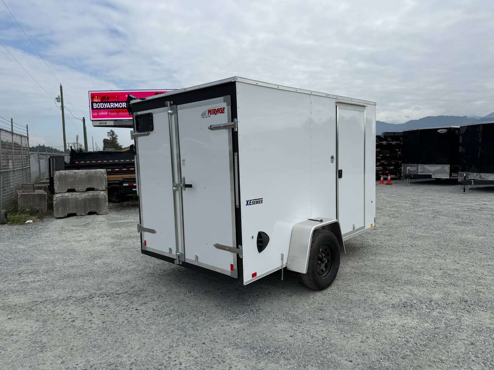 Photo of 2026 Mirage XE 6x10 Enclosed Cargo Trailer V Nose Barn Doors White Standard Height 2990lb GVW