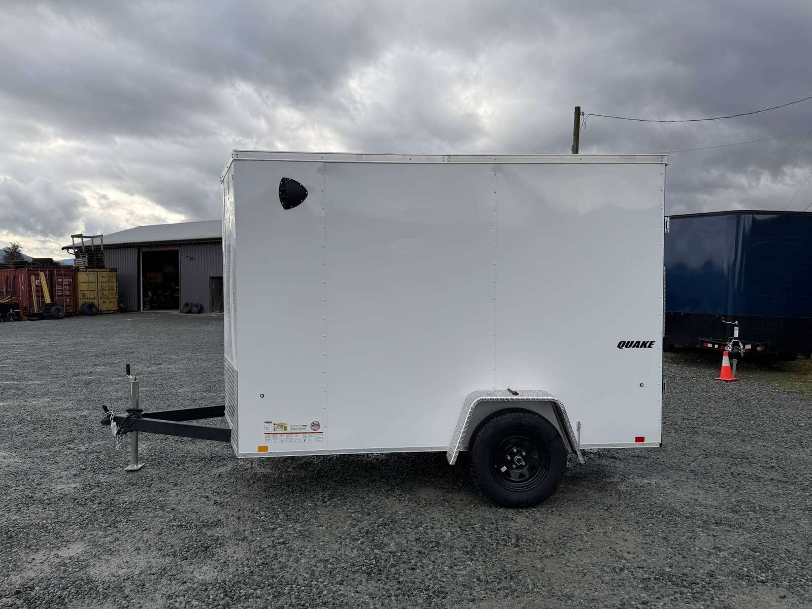 Photo of 2026 Impact Quake 6x10 V Nose Cargo / Enclosed Trailer White Barn Doors Extra Height 2990lb GVW