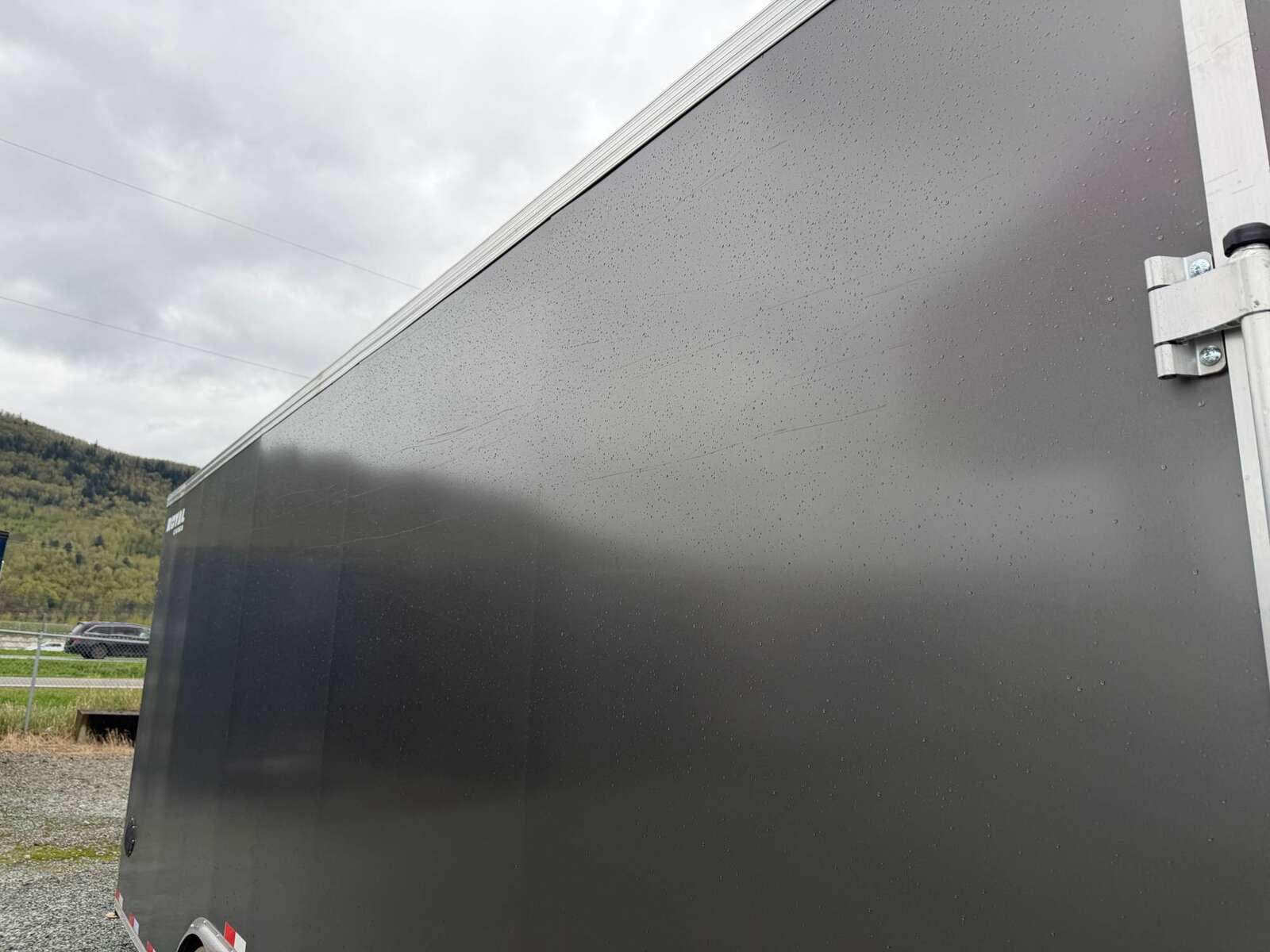 Photo of **SCRATCH SALE** 2026 Royal Cargo 8.5x24 V Nose Car Hauler Cargo / Enclosed Trailer 11,400lb GVW Charcoal Grey Ramp Door Extra Height (GSR)