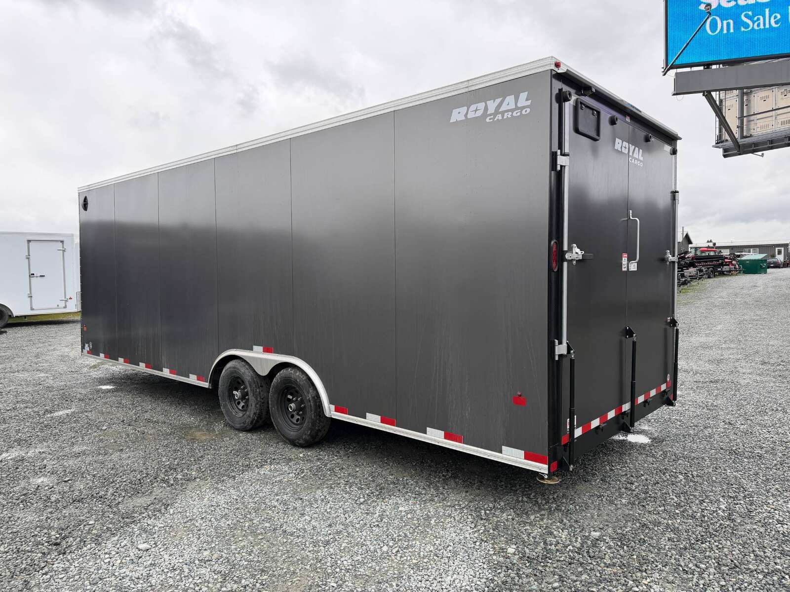 Photo of **SCRATCH SALE** 2026 Royal Cargo 8.5x24 V Nose Car Hauler Cargo / Enclosed Trailer 11,400lb GVW Charcoal Grey Ramp Door Extra Height (GSR)