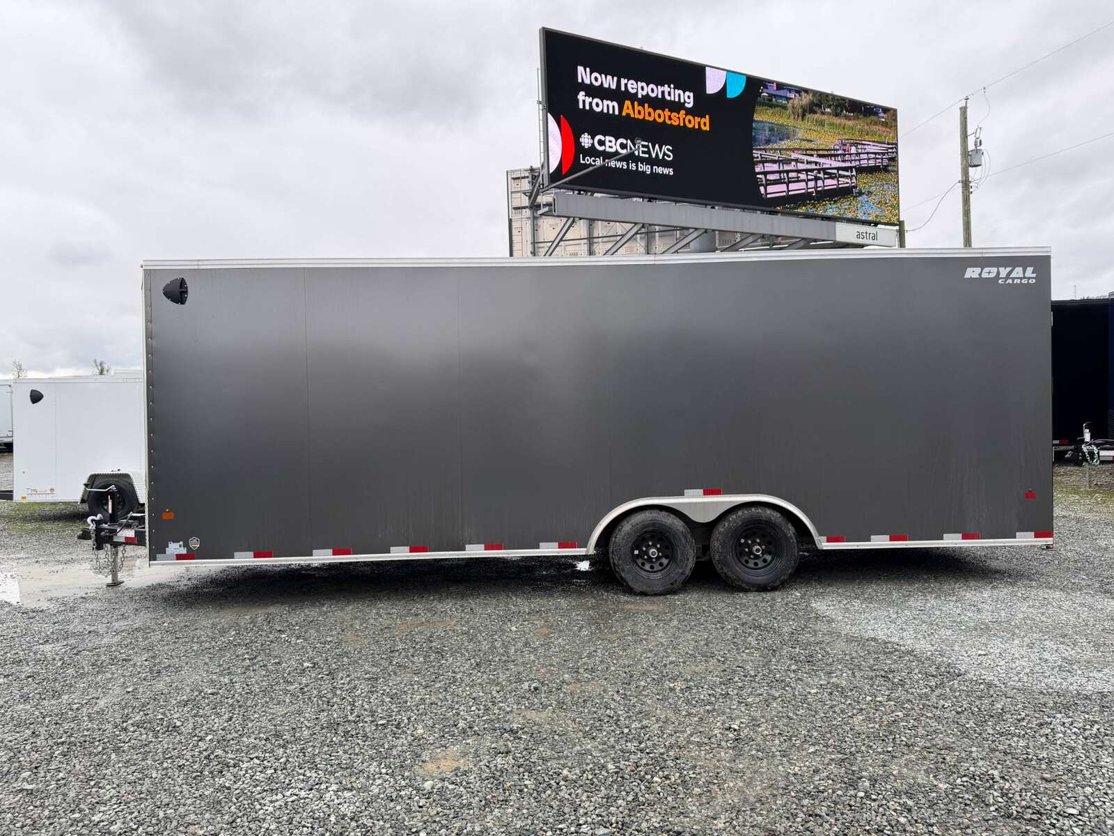 Photo of **SCRATCH SALE** 2026 Royal Cargo 8.5x24 V Nose Car Hauler Cargo / Enclosed Trailer 11,400lb GVW Charcoal Grey Ramp Door Extra Height (GSR)