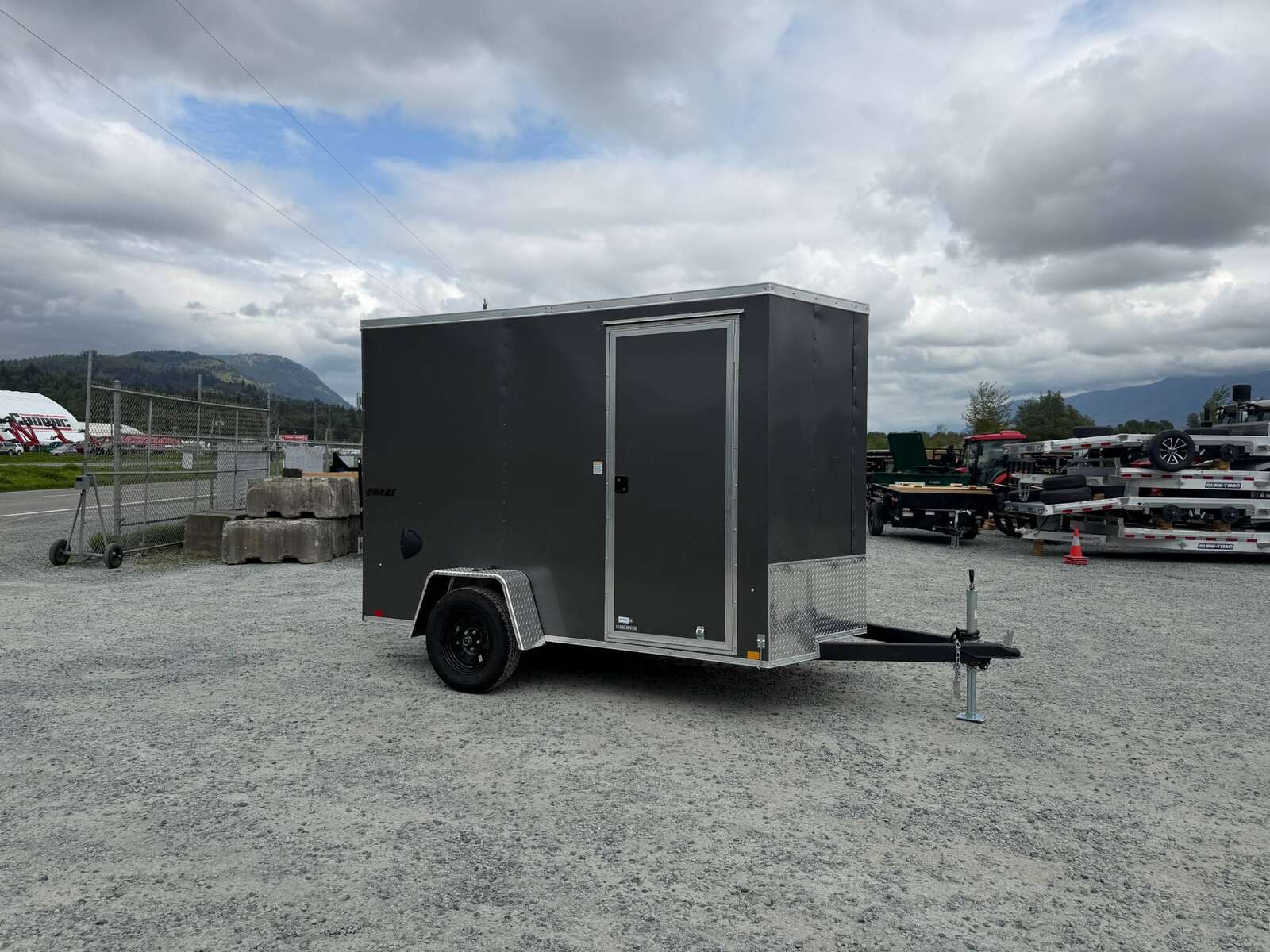 Photo of 2026 Impact Quake 6x10 V Nose Cargo / Enclosed Trailer Charcoal Grey Ramp Door Extra Height 2990lb GVW