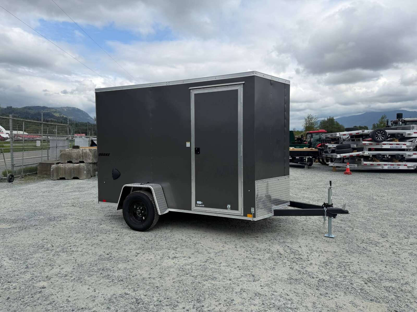 Photo of 2026 Impact Quake 6x10 V Nose Cargo / Enclosed Trailer Charcoal Grey Ramp Door Extra Height 2990lb GVW