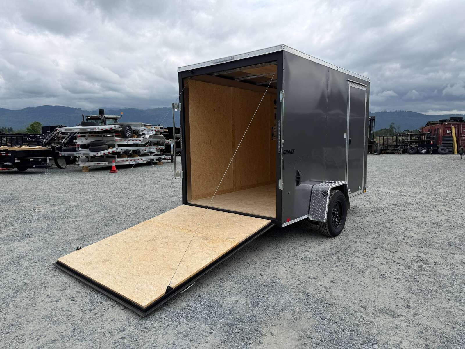 Photo of 2026 Impact Quake 6x10 V Nose Cargo / Enclosed Trailer Charcoal Grey Ramp Door Extra Height 2990lb GVW