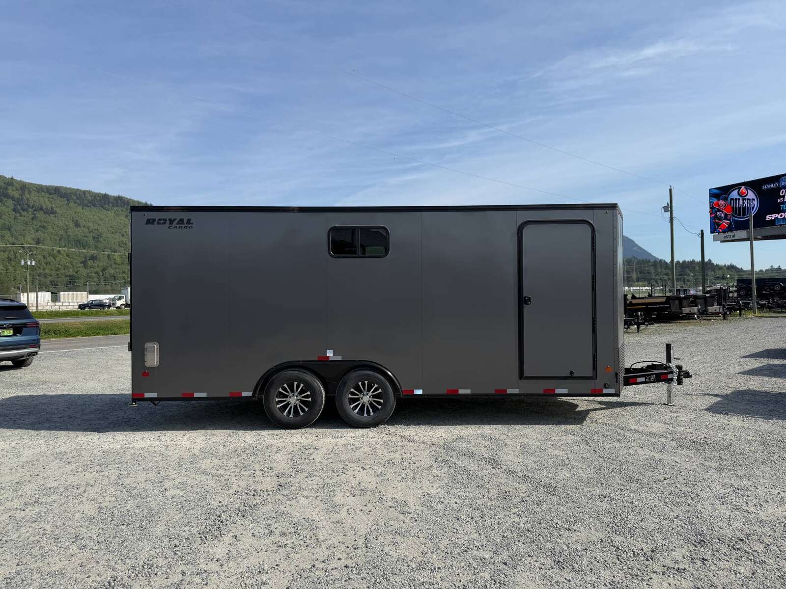 Photo of 2026 Royal 8.5x20 V Nose Cargo Enclosed Trailer Camping Package Charcoal Grey w/ Blackout Pkg, Insulated, Ramp Door, White Walls, 2x Windows & More!