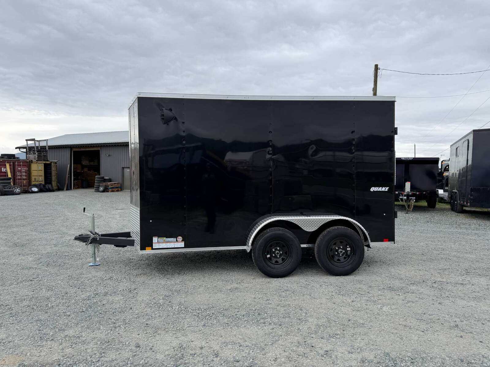 Photo of 2026 Impact Quake 6x12 V Nose Cargo / Enclosed Trailer Tandem Axle Black Barn Doors Extra Height 7000lb GVW