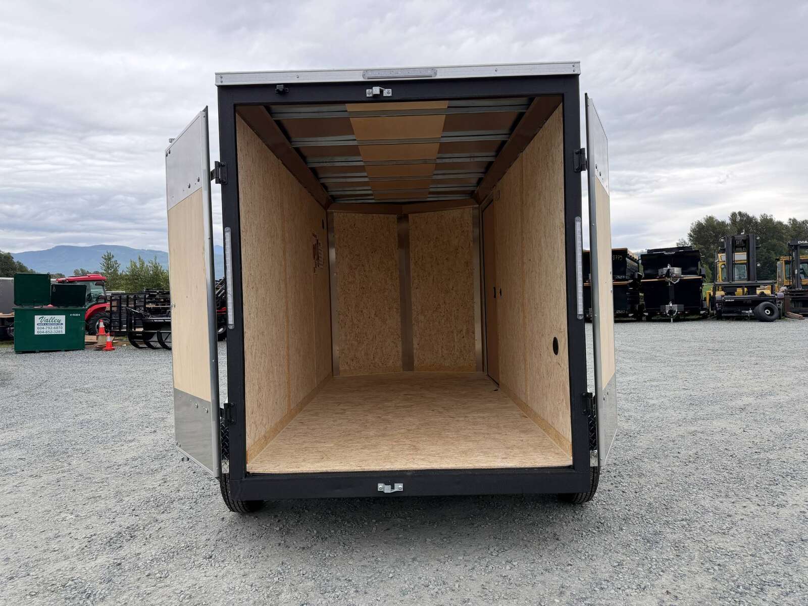 Photo of 2026 Impact Quake 6x12 V Nose Cargo / Enclosed Trailer Tandem Axle Black Barn Doors Extra Height 7000lb GVW