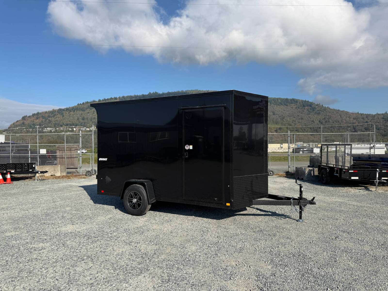 Photo of 2027 Impact Quake 7x12 V Nose Cargo / Enclosed Trailer / Black Polycor Exterior / 5000lb GVW Brake Axle w/ Ramp Door