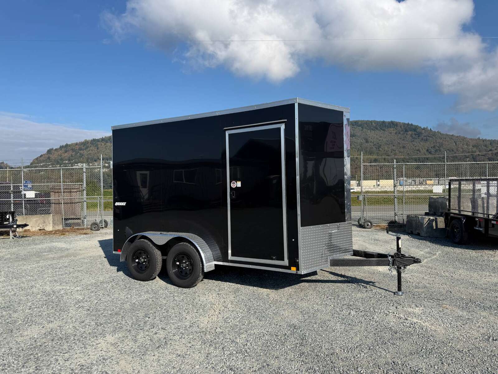 Photo of 2027 Impact Quake 7x12 Cargo Enclosed Trailer Tandem Axle 7000lb GVW / POLYCOR Black Exterior / Extra Height w/ Ramp Door