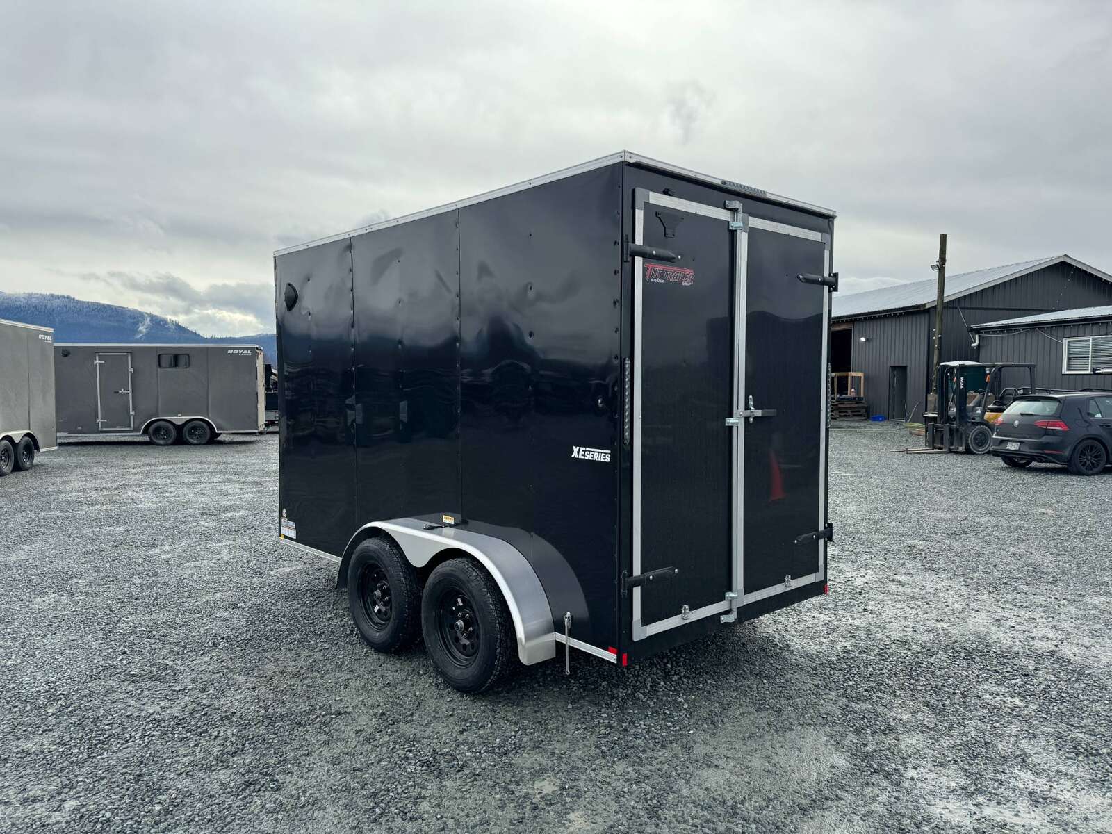 Photo of 2024 Mirage XE 6x12 V Nose Tandem Axle Cargo / Enclosed Trailer Black Barn Doors Extra Height 7,000lb GVW