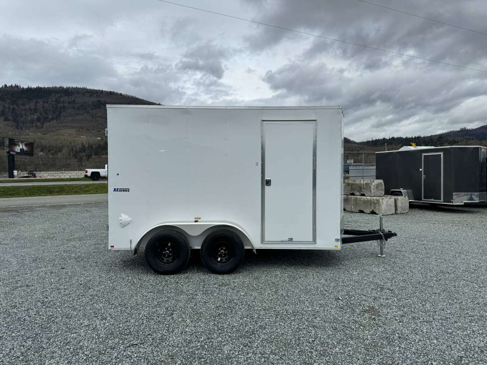 Photo of 2025 Mirage XE 6x12 V Nose Tandem Axle Cargo / Enclosed Trailer White Barn Doors Extra Height 7,000lb GVW