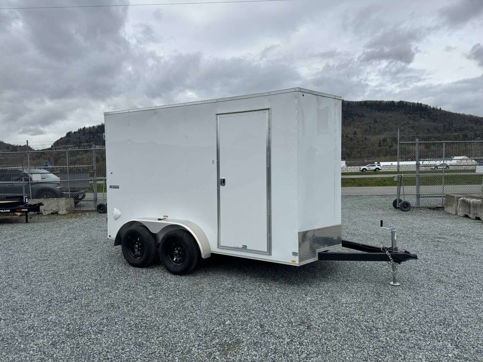 Photo of 2025 Mirage XE 6x12 V Nose Tandem Axle Cargo / Enclosed Trailer White Barn Doors Extra Height 7,000lb GVW