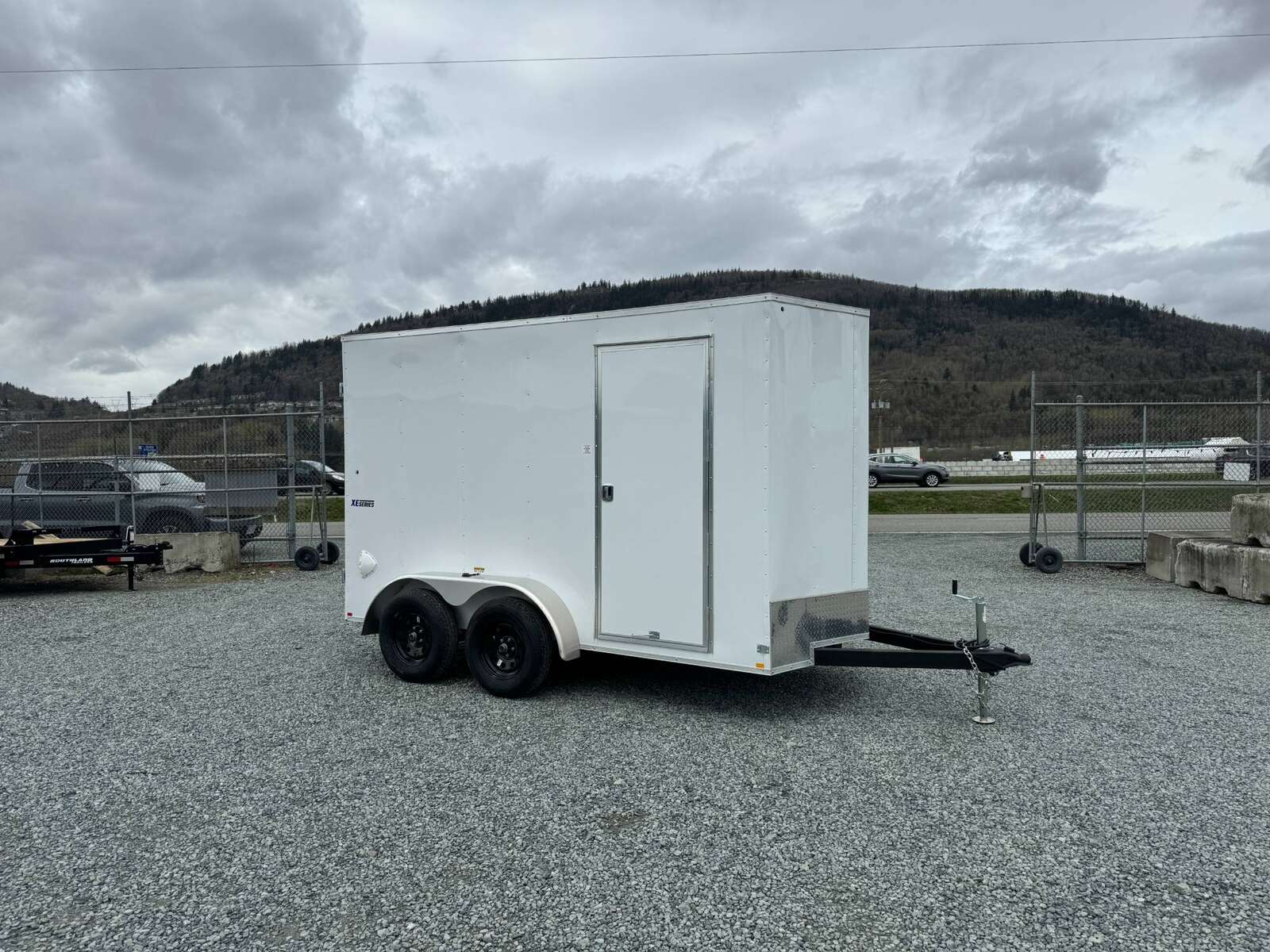 Photo of 2025 Mirage XE 6x12 V Nose Tandem Axle Cargo / Enclosed Trailer White Barn Doors Extra Height 7,000lb GVW