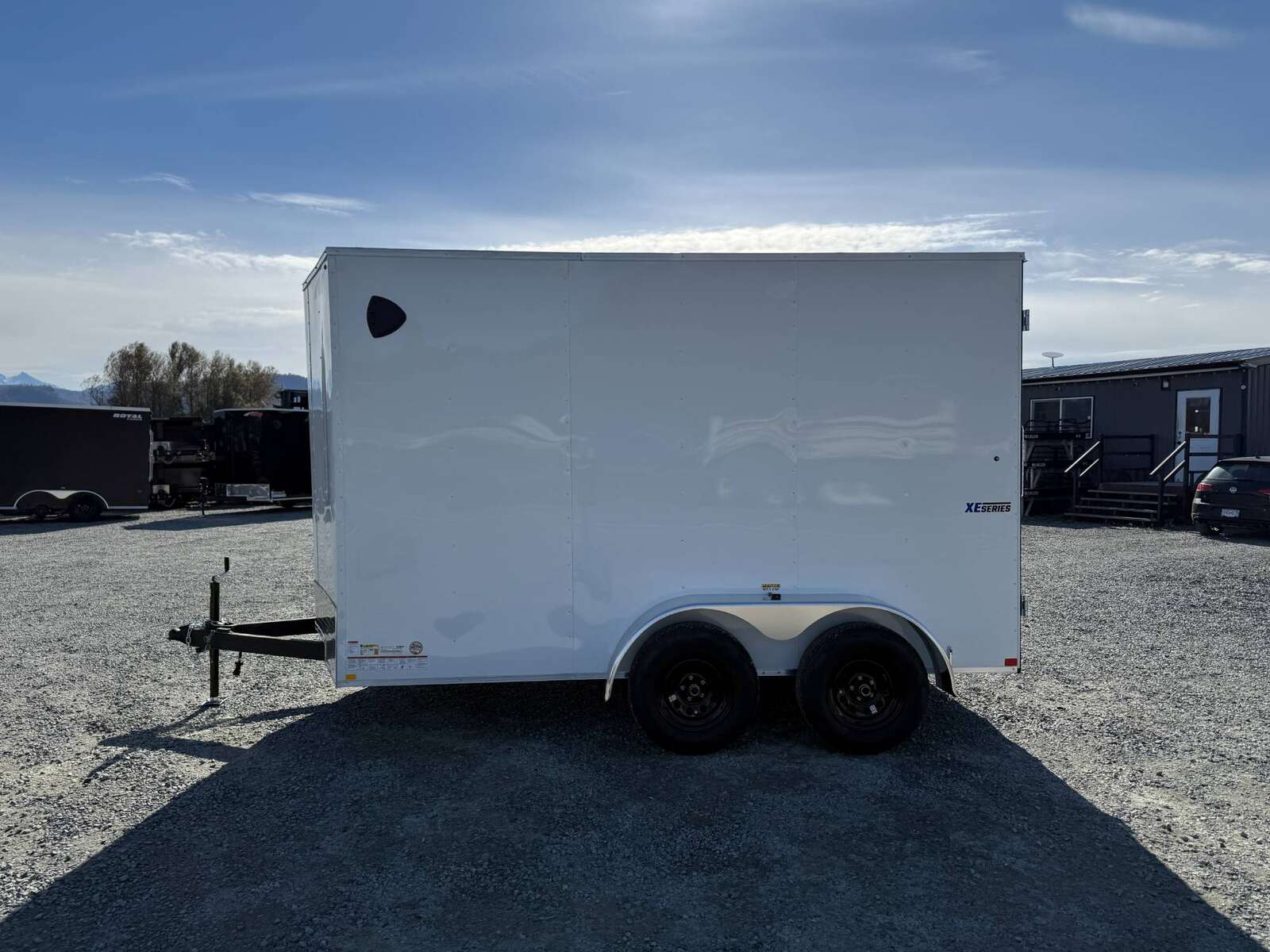 Photo of 2025 Mirage Trailers XE 7x12 V Nose Cargo / Enclosed Trailer Tandem Axle Extra Height Rear Barn Doors White 7000lb GVW