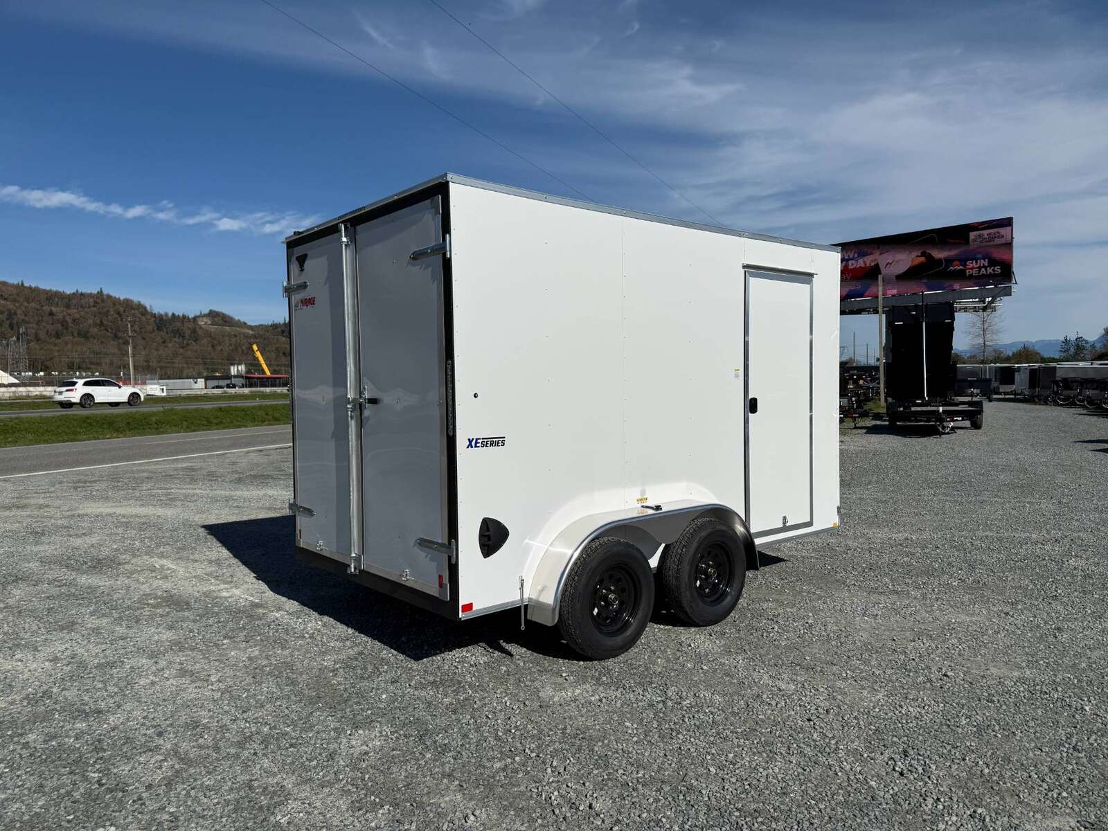 Photo of 2025 Mirage Trailers XE 7x12 V Nose Cargo / Enclosed Trailer Tandem Axle Extra Height Rear Barn Doors White 7000lb GVW